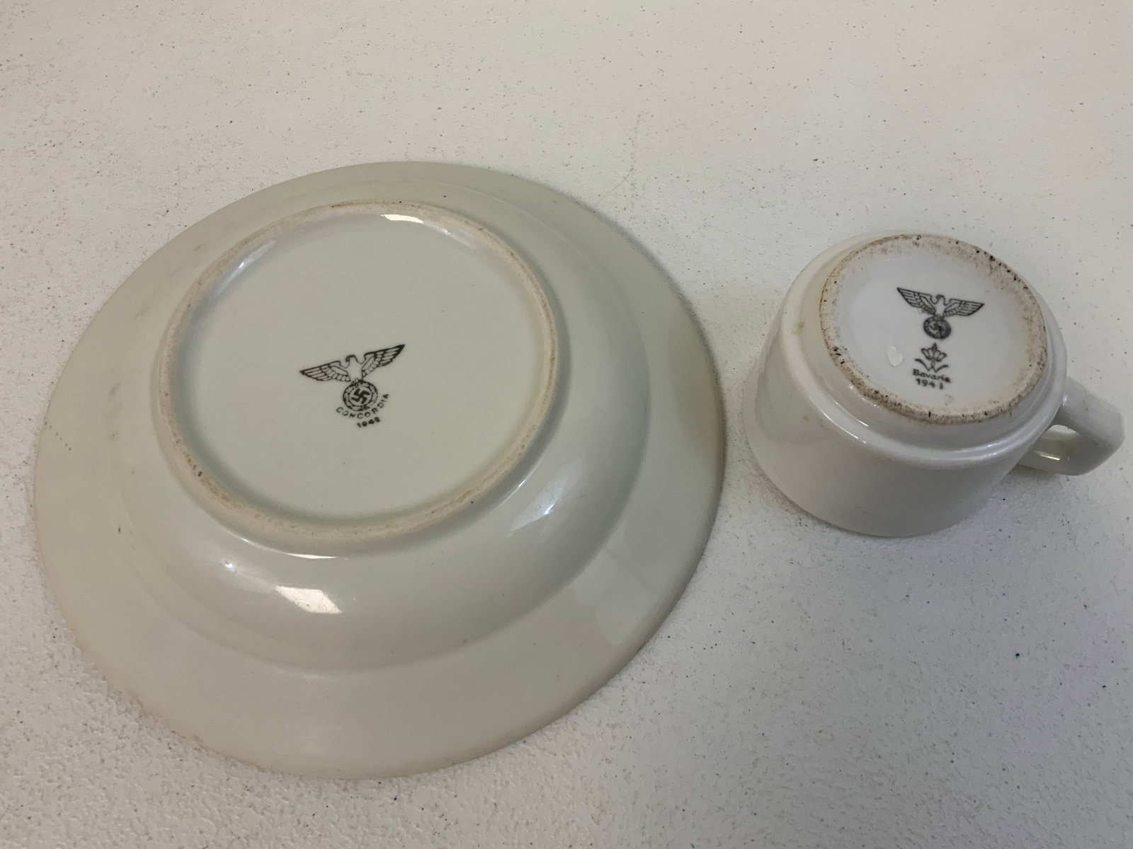 WWII GERMAN MILITARY PORCELAIN COFFEE MUG AND DINNER PLATE: WWII GERMAN MILITARY PORCELAIN COFFEE MUG AND DINNER PLATE . NICELY MARKED AND DATED. 9 1/4 DIAM. PLATE AND 3 1/2" MUG. GOOD CONDITION.