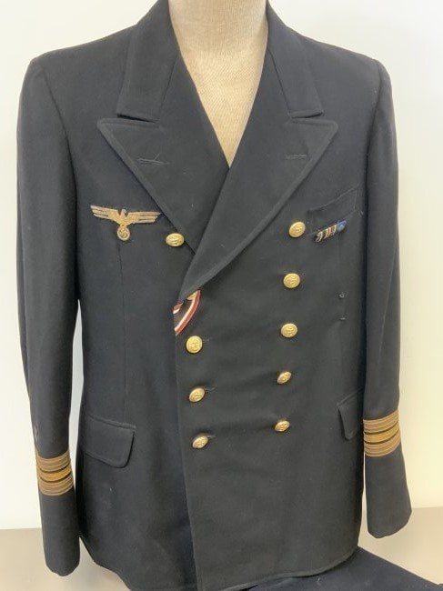WWII GERMAN NAVY KRIEGSMARINE ORDINANCE OFFICER UNIFORM TUNIC AND PANTS: WWII GERMAN NAVY KRIEGSMARINE ORDINANCE OFFICER UNIFORM . RARE FIND. DARK BLUE ALMOST BLACK COLOR TUNIC WITH GOLD BULLION EAGLE AND SLEEVE STRIPES WITH ORDINANCE INSIGNIAS. NAMED INSIDE POCKET ON THE 
