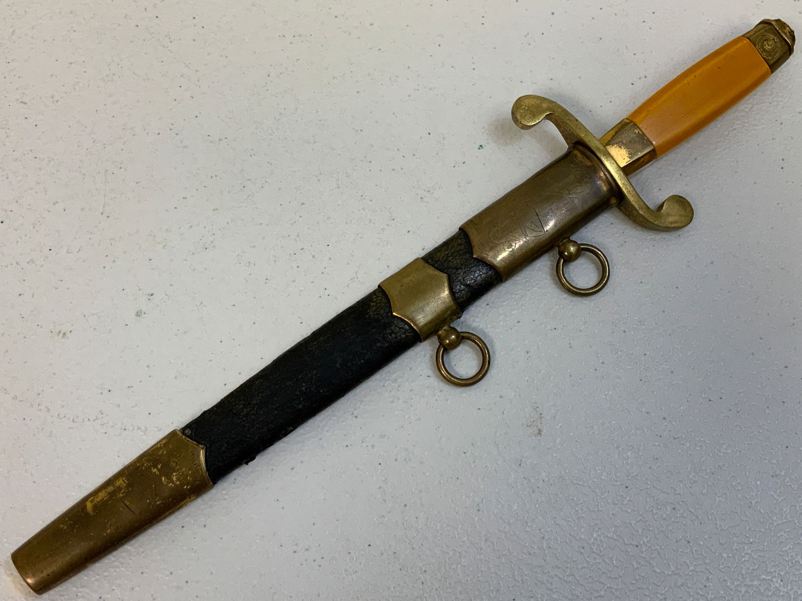 USSR WWII NAVY OFFICERS DAGGER: USSR WWII NAVY OFFICERS DAGGER . EARLY DAGGER PRODUCED DURING WWII. BLADE IS POLISHED BUT STILL VISIBLE "IMZ 1944" ON ONE SIDE AND REMNANTS OF THE SERIAL NUMBER ON THE OTER. LEATHER COVERED SCABBARD W