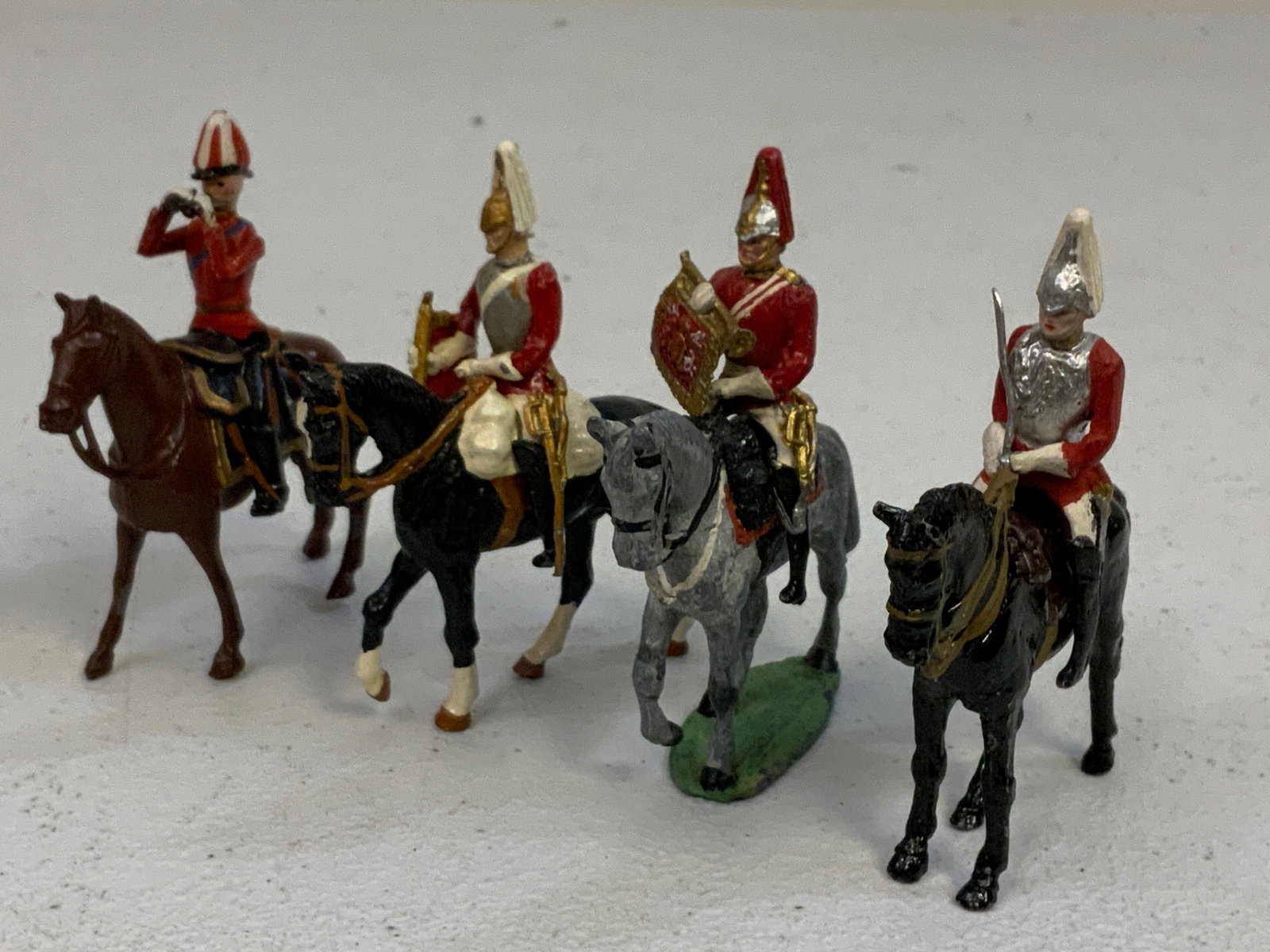 LOT OF PAINTED LEAD TOY SOLDIERS - UK ON HORSE: LOT OF PAINTED LEAD TOY SOLDIERS - UK ON HORSE LOT OF 4 . 2" TALL SOLDIERS.