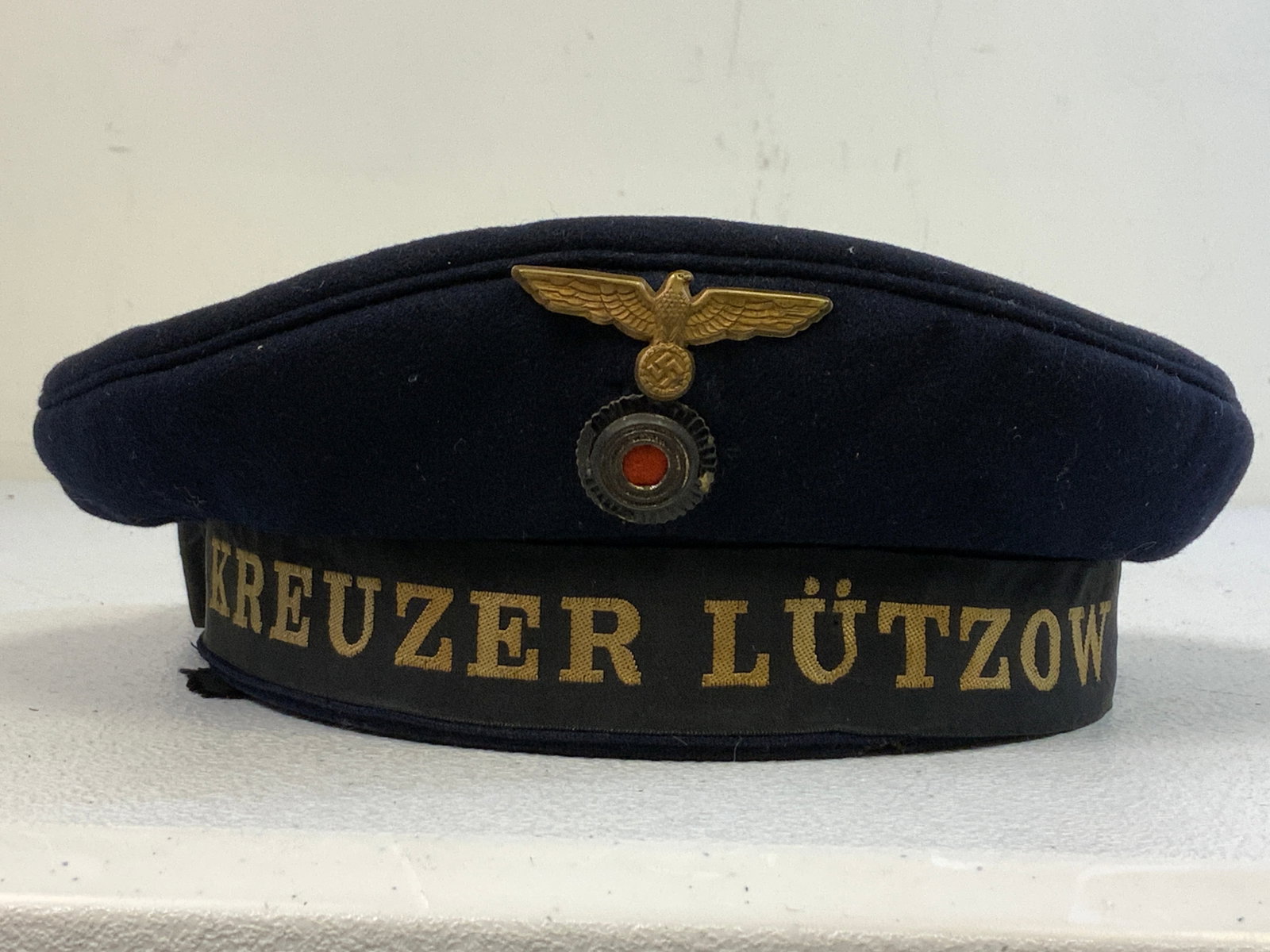 GERMANY THIRD REICH RARE KREUZER LUTZOW SAILOR CAP: GERMANY THIRD REICH RARE KREUZER LUTZOW SAILOR CAP . VERY GOOD CONDITION OVERALL WITH SOME TEARS TO THE TALLIES ON THE BACK. MAKER MARK AND LEATHER SWEATBAND STILL INTACT. Lützow was a heavy cruiser 