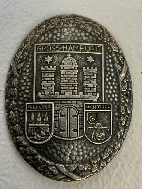 ANTIQUE GERMAN "GROSS HAMBURG" PLAQUE: ANTIQUE GERMAN "GROSS HAMBURG" PLAQUE . SILVER METAL OVAL WITH 4 MOUNTING HOLES. 2 3/8 X 1 3/4