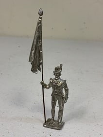 UNPAINTED LEAD TOY SOLDIER WITH FLAG .