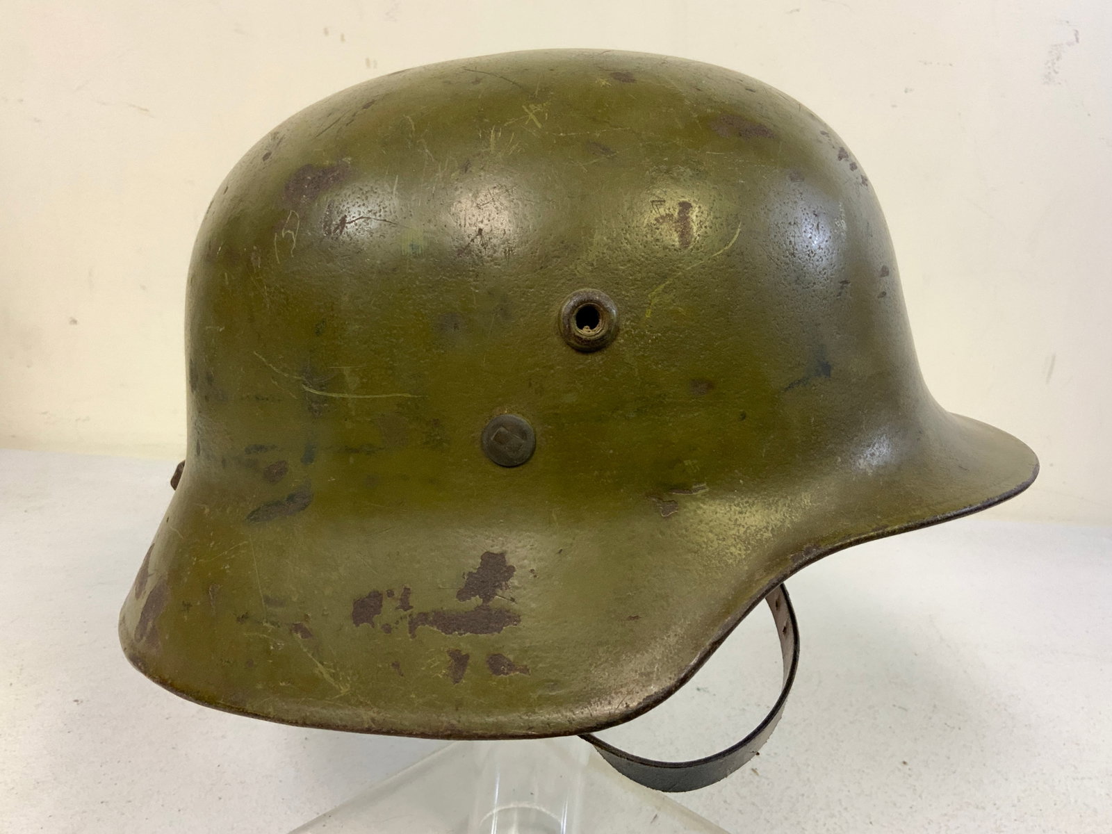 WWII HUNGARIAN ARMY M38 HELMET: WWII HUNGARIAN ARMY M38 HELMET. GREAT EXAMPLE WITH ORIGINAL PAINT LINER AND CHIN STRAP.