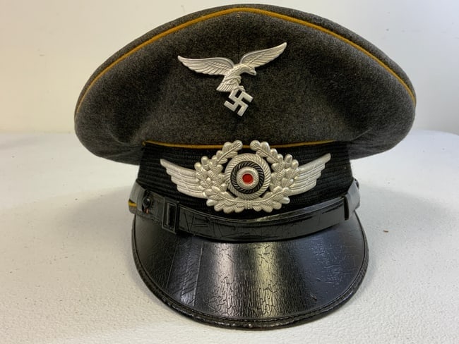WWII GERMAN LUFTWAFFE FLIGHT NCO VISOR CAP: WWII GERMAN LUFTWAFFE FLIGHT NCO VISOR CAP . EARLY ALUMINUM DROOP TAIL EAGLE . GOOD CONDITION OVERALL.