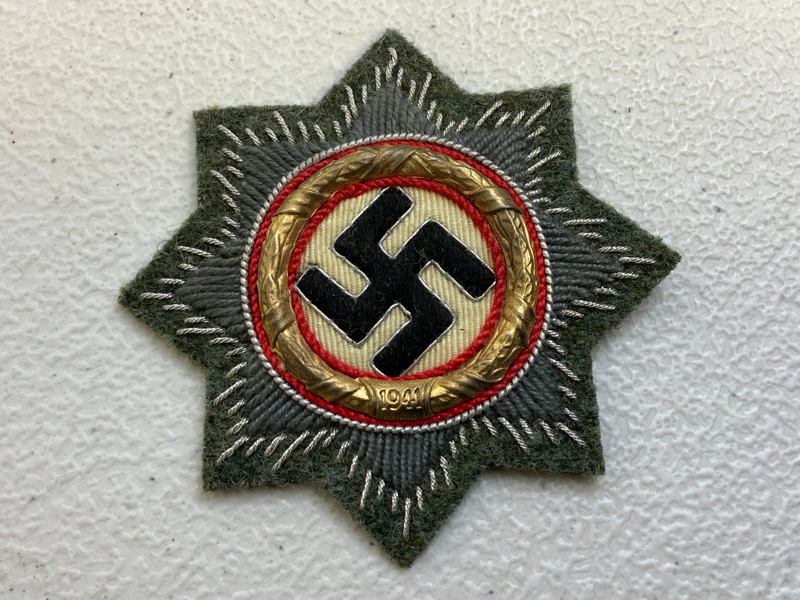 GERMANY THIRD REICH WWII 1941 GERMAN CROSS IN GOLD CLOTH VARIATION: GERMANY THIRD REICH WWII 1941 GERMAN CROSS IN GOLD CLOTH VARIATION. VERY NICE AND CLEAN CONDITION. HIGH QUALITY EMBROIDERY .BLACK PAPER TYPE BACKING. NEVER USED.