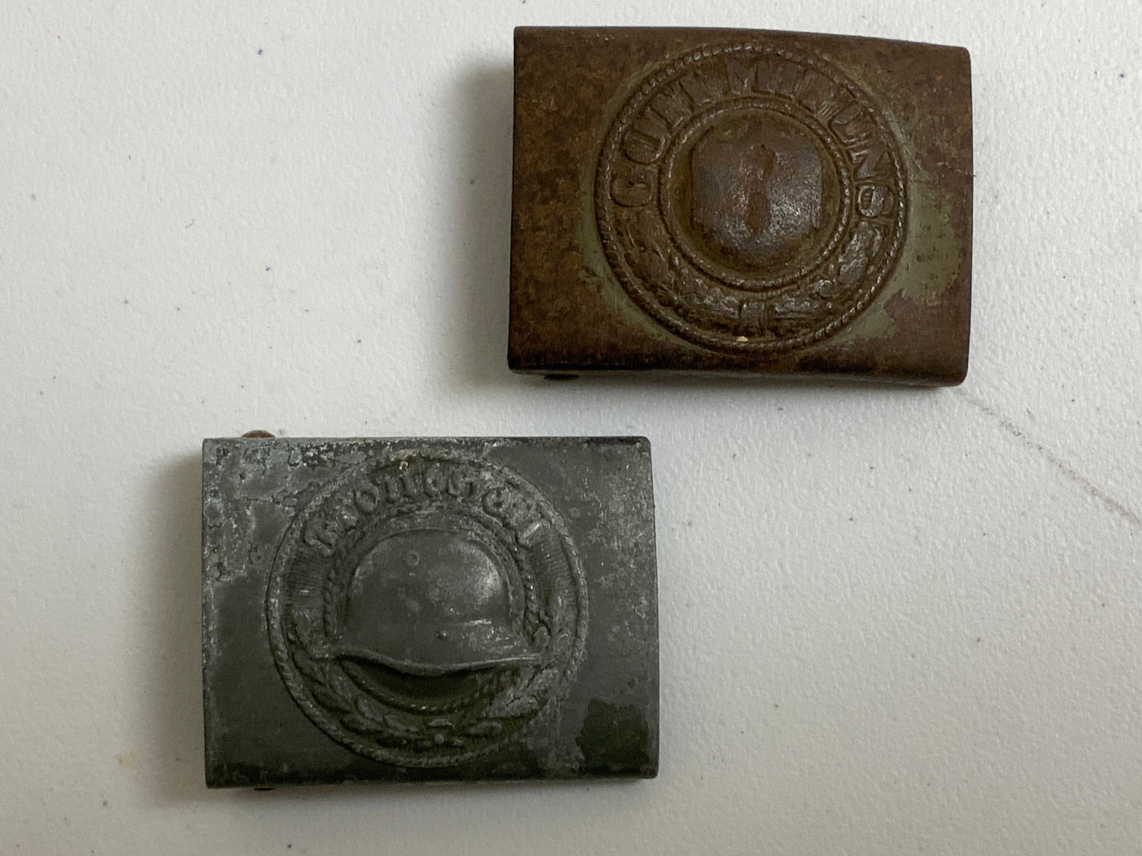 WW2 GERMAN STAHLHELM AND ARMY BELT BUCKLES: WW2 GERMAN STAHLHELM AND ARMY BELT BUCKLES. WELL WORN AND USED. ARMY EAGLE IS RUBBED OFF.