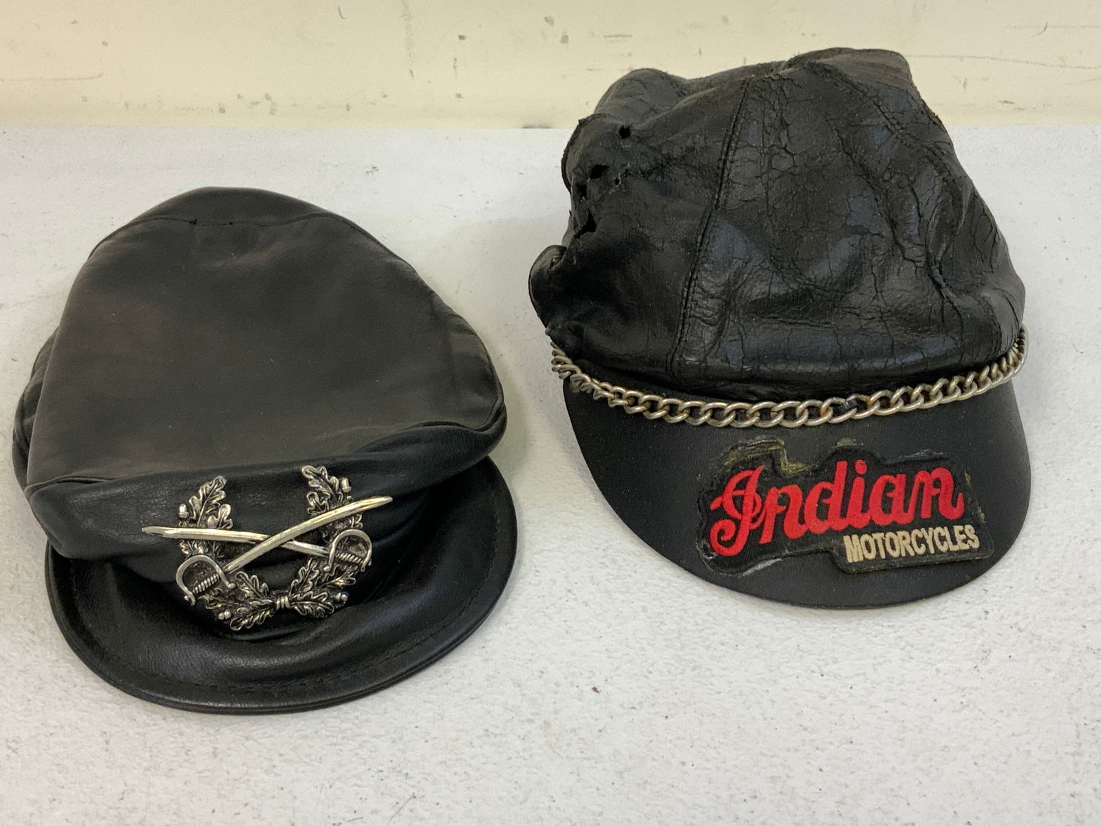 VINTAGE BLACK LEATHER MOTORCYCLE BIKER CAPS: VINTAGE BLACK LEATHER MOTORCYCLE BIKER CAPS. ONE IS WELL USED CONDITION WITH HOLES AND MUCH WEAR. OTER IS IN VERY GOOD CONDITION.