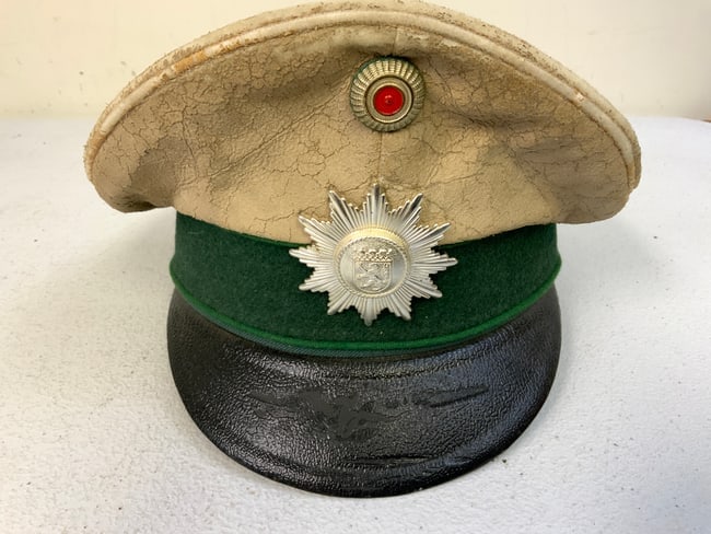 VINTAGE WEST GERMANY POLICE OFFICER VISOR HAT: WEST GERMANY POLICE OFFICER VISOR HAT. WELL WORN CONDITION. MAKER MARKED AND 1972 DATED. SIZE 55.