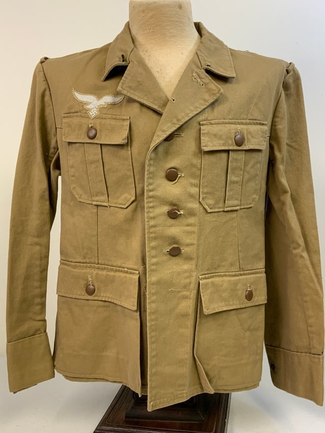 WWII GERMAN LUFTWAFFE DAK TROPICAL AFRIKA KORPS TUNIC: WWII GERMAN LUFTWAFFE DAK TROPICAL AFRIKA KORPS TUNIC. MINT , NEVER ISSUED CONDITION. INK STAMPS INSIDE. ORIGINAL PAPER TAG STILL ATTATCHED TO THE FRONT LOWER . VERY RARE TO FIND.