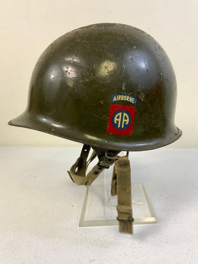 WWII US ARMY 82nd AIRBORNE DIVISION M1C PARATROOPER HELMET WITH LINER: WWII US ARMY 82nd AIRBORNE DIVISION M1C PARATROOPER HELMET WITH LINER . ORIGINAL HELMET AND LINER . DECALS TO THE SIDES. NAMED INSIDE THE SHELL. LINER IS IN GREAT CONDITION COMPLETE WITH ITS STRAPS. W