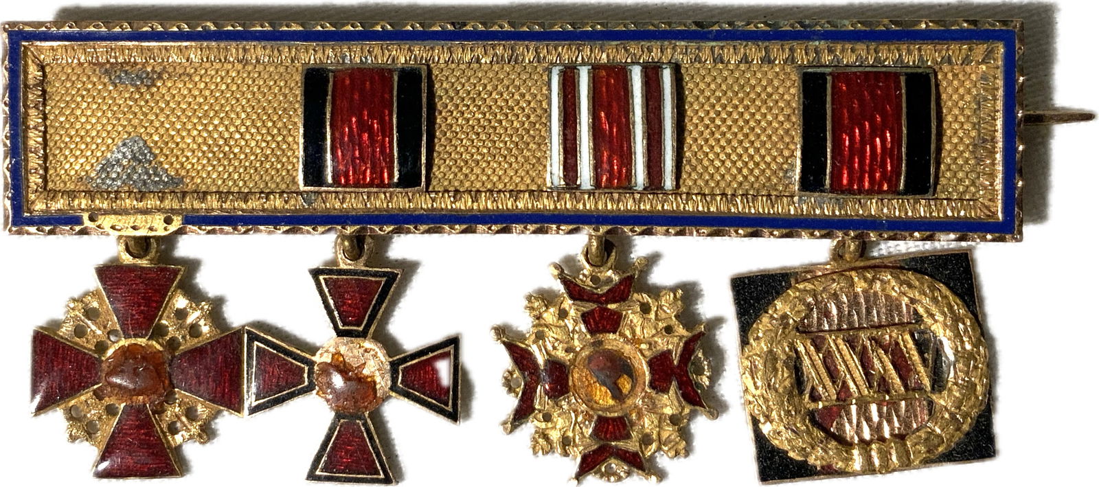 IMPERIAL RUSSIAN MINIATURE ORDERS AWARD BAR: IMPERIAL RUSSIAN MINIATURE ORDERS AWARD BAR. 4 PLACE MINIATURE AWARDS IN GILDED SILVER AND ENAMELS. SOME ENAMEL LOSS. HALLMARKED. RARE.