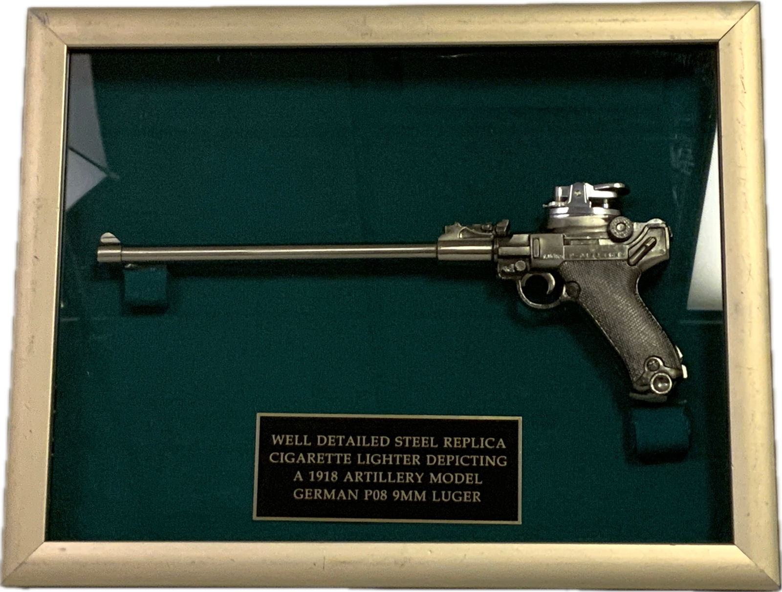 WELL DETAILED STEEL REPLICA P08 ARTILLERY LUGER CIGARETTE LIGHTER FRAMED: WELL DETAILED STEEL REPLICA CIGARETTE LIGHTER DEPICTIING A 1918 ARTILLERY MODEL GERMAN P08 LUGER. FRAMED IN 14" X 11" FRAME. THE GUN IS 11" LONG.