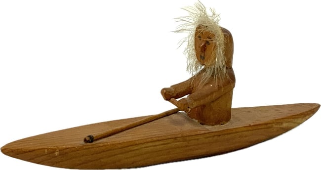 VINTAGE WOODEN INUIT ON BOAT FIGURINE: VINTAGE WOODEN INUIT ON BOAT FIGURINE. 6" LONG.
