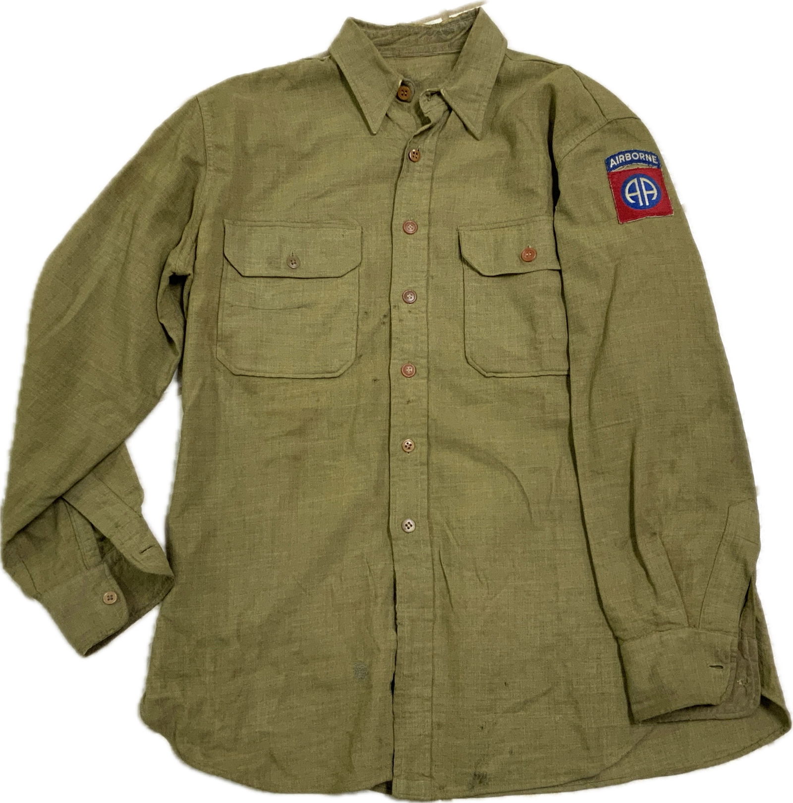 USA WWII ARMY 82nd AIRBORNE DIVISION FLANNEL SHIRT: USA WWII ARMY 82nd AIRBORNE DIVISION FLANNEL SHIRT.In well worn condition an US WWII 82nd Airborne Division Paratrooper Flannel Shirt. The shirt comes in Large size and with the insignia are original