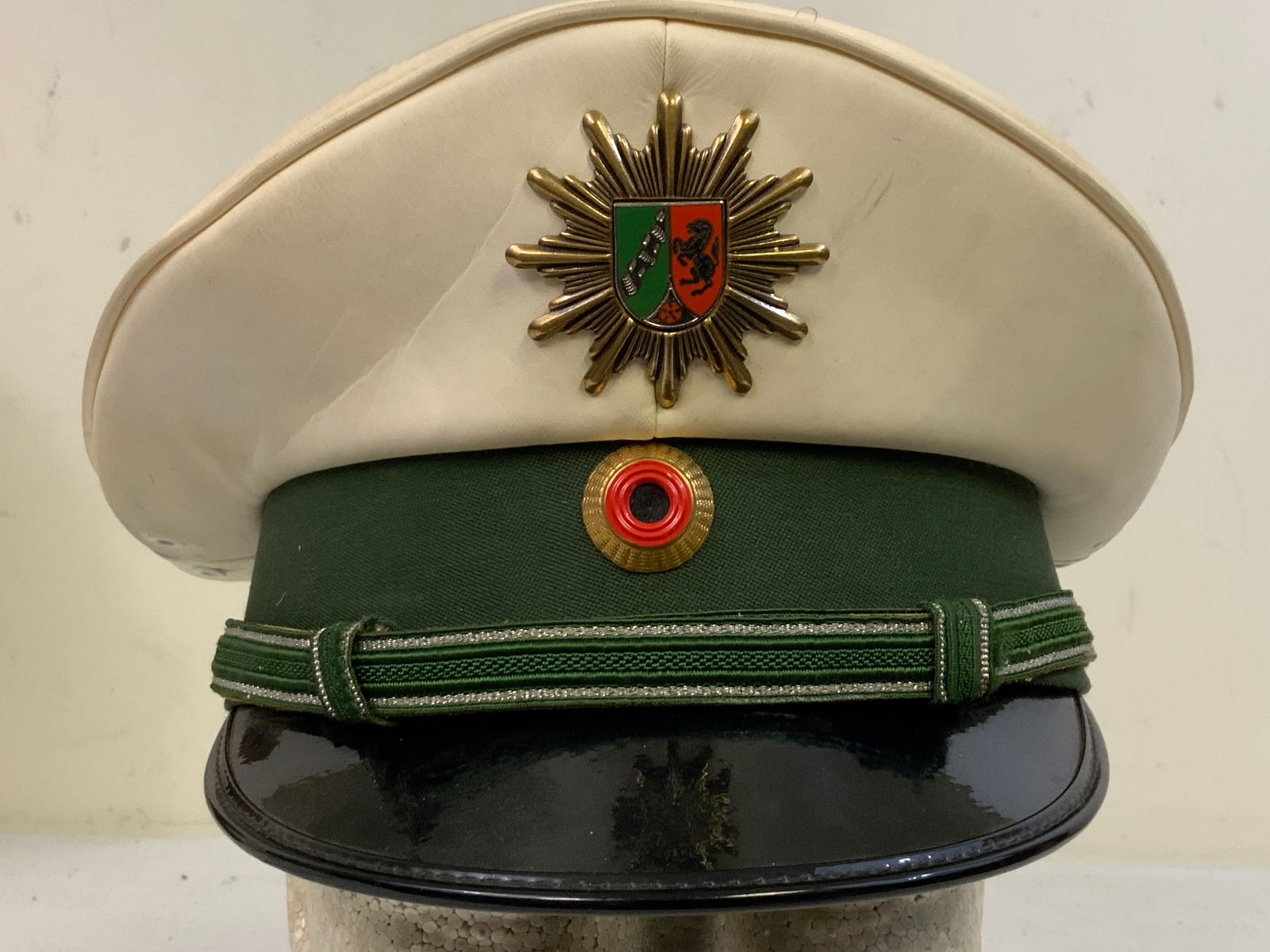 GERMANY GERMAN POLICE OFFICERS WHITE TOP VISOR HAT: GERMANY GERMAN POLICE OFFICERS WHITE TOP VISOR HAT. GOOD USED CONDITION.SIMULATED LEATHER LIKE MATERIAL TOP. SIZE 57.