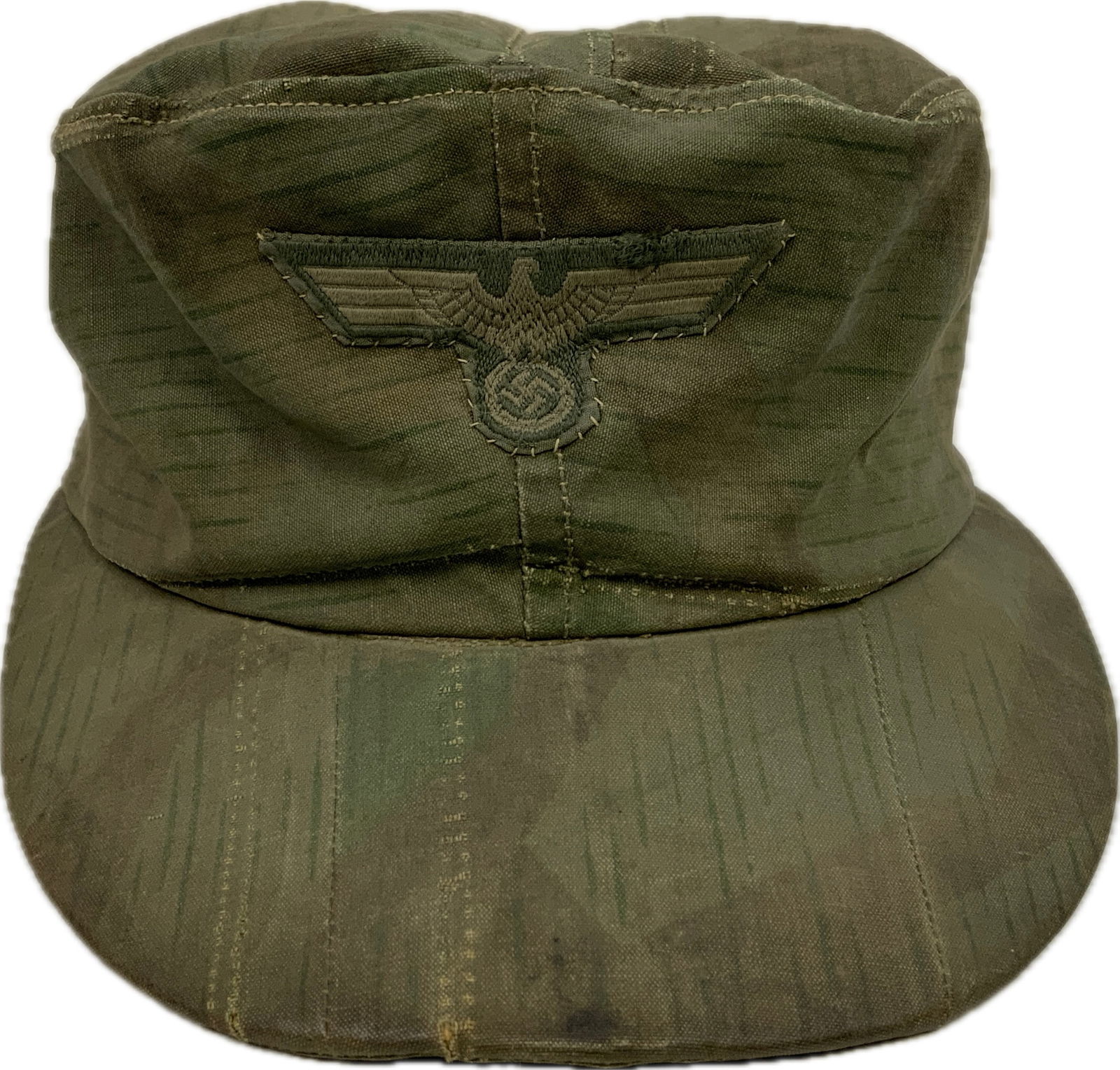 WWII GERMAN ARMY CAMOUFLAGE FIELD CAP: WWII GERMAN ARMY CAMOUFLAGE FIELD CAP. FIELD MADE FROM ARMY CAMOUFLAGE ZELTBAHN MATERIAL. HAND APPLIED INSIGNIA. WELL WORN GREAT EXAMPLE. SIZE ABOUT 57.
