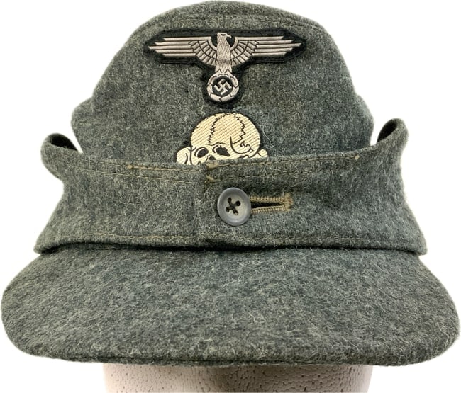 WWII GERMAN WAFFEN SS M43 WOOL FIELD CAP: WWII GERMAN WAFFEN SS M43 WOOL FIELD CAP.WELL WORN WITH SOME HOLES MOSTLY ON THE BACK. RIBBED COTTON STYLE LINING WITH INK STAMP 59 FOR SIZE. GREAT EXAMPLE.