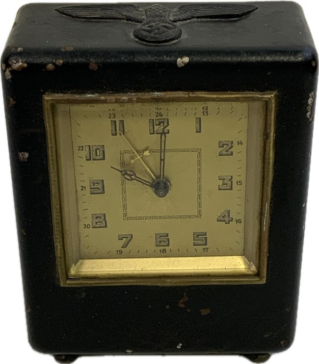 GERMANY THIRD REICH RARE CLOCK COIN BANK: GERMANY THIRD REICH RARE CLOCK COIN BANK. 3 3/4 X 4 1/2 X 1 3/4 METAL BODY. EAGLE ON THE TOP. METAL PLAQUE ON THE BACK WITH THE BANK NAME. SLOT ON THE BACK TO DROP THE COINS. THERE ARE COINS INSIDE BU