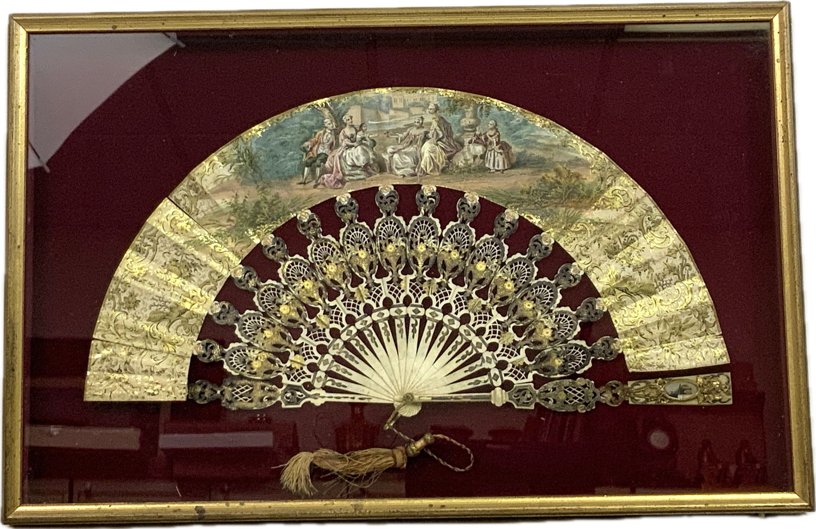 ANTIQUE FRENCH 19th CENTURY LARGE LADY'S FAN FRAMED AND MOUNTED: ANTIQUE FRENCH 19th CENTURY LARGE LADY'S FAN FRAMED AND MOUNTED. BEAUTIFUL HIGH QUALITY PIECE WITH PAINTED SCENE AND DETAILS. APEARS TO BE DECORATED AND GILDED BONE CARVED VANES. INCLUDES PERSONAL LAD