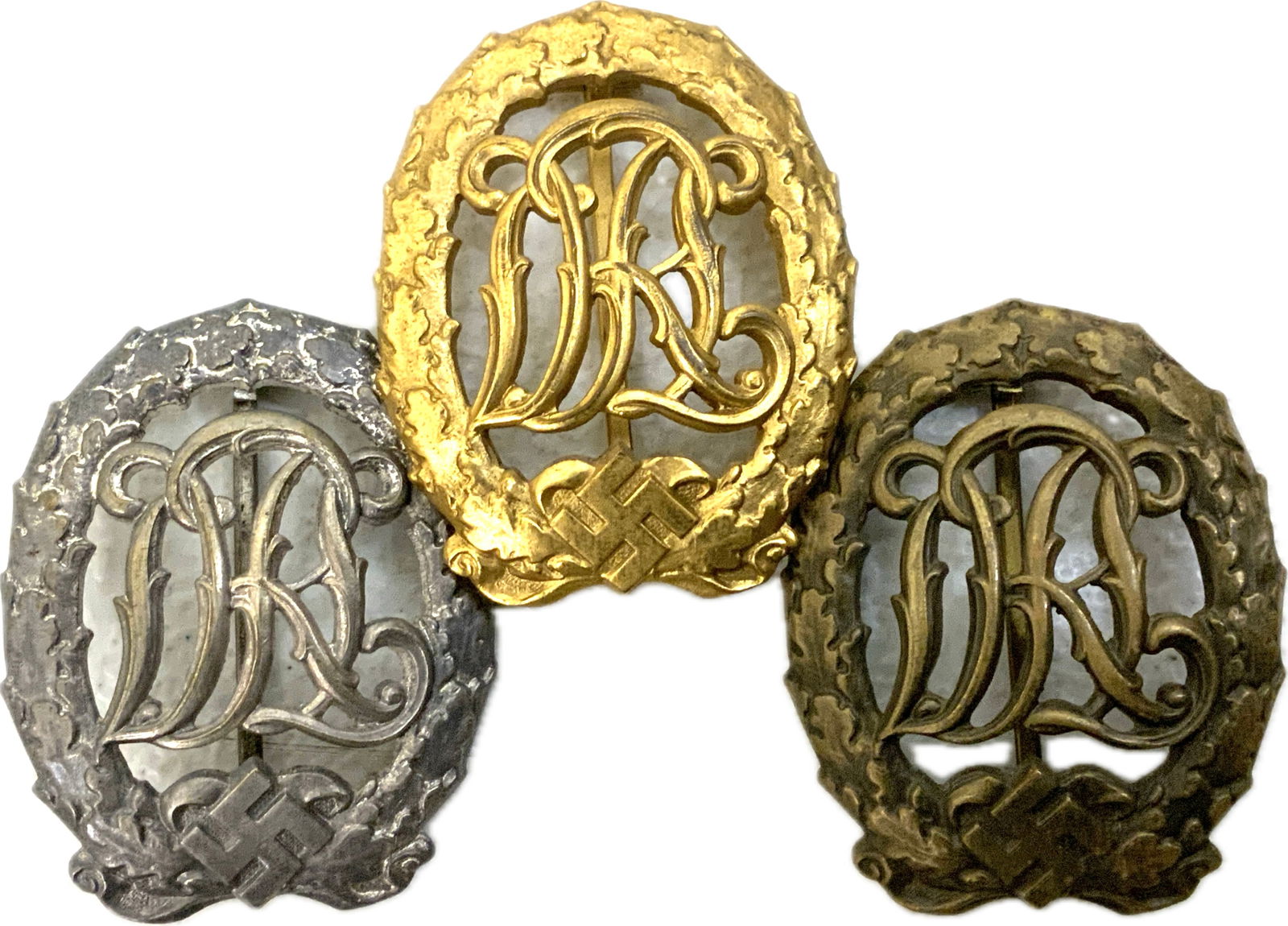 GERMANY THIRD REICH DRL SPORTS BADGES - GOLD, SILVER AND BRONZE: GERMANY THIRD REICH DRL SPORTS BADGES - GOLD, SILVER AND BRONZE. ALL 3 GRADES. GREAT CONDITION. ALL MARKED ON THE BACK.