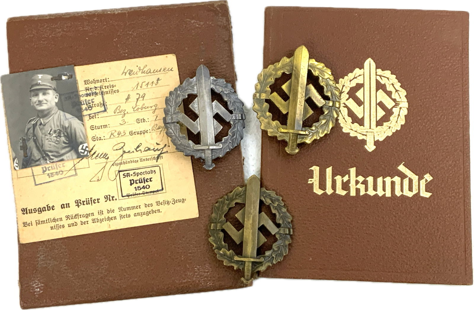 GERMANY THIRD REICH SA SPORT AWARD BADGES ALL 3 GRADES WITH DOCUMENTS: NAZI GERMANY SA SPORT AWARD BADGES ALL 3 GRADES WITH DOCUMENTS . VERY NICE GROUPING . GOLD , SILVER AND BRONZE GRADES SA SPORT BADGES ALONG WITH PICTURE DOCUMENTS