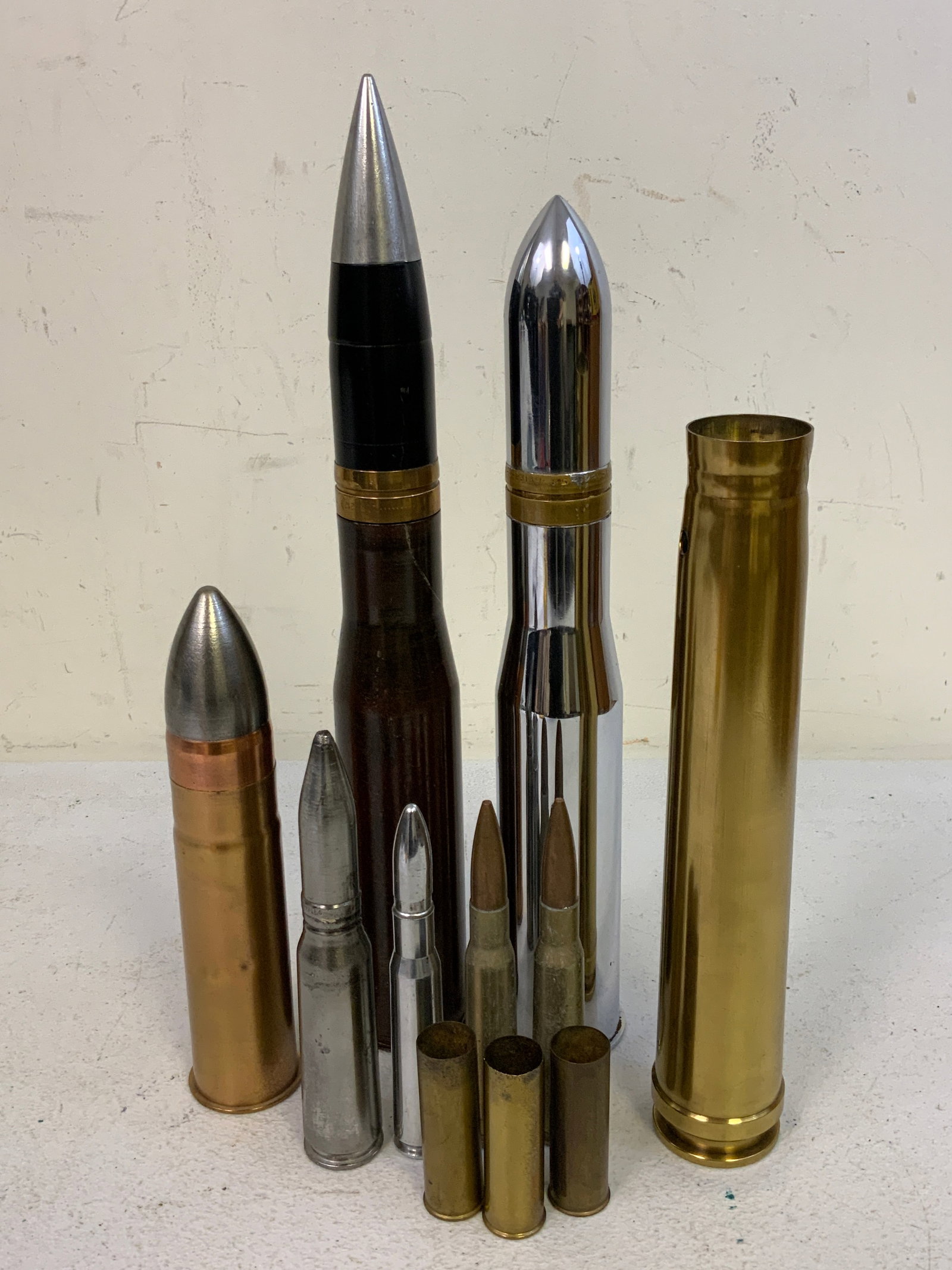 INERT AND TRAINING DUMMY AMMO LARGE CALIBER ROUNDS: INERT AND TRAINING DUMMY AMMO LARGE CALIBER ROUNDS. LOT OF 11. 15" THE TALLEST ONE. USA SHIPPING ONLY.