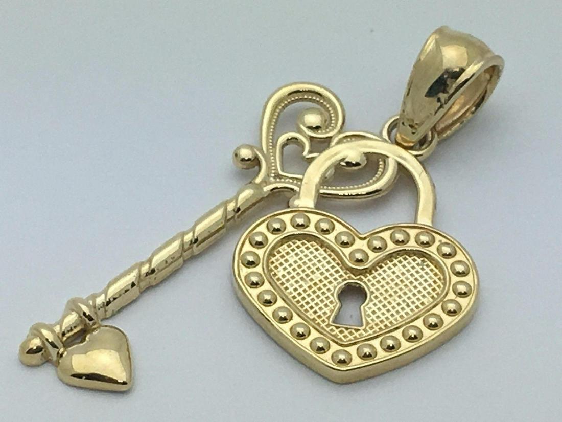 14Kt YELLOW GOLD HEART LOCK W KEY TO MY HEART PENDANT: 14Kt YELLOW GOLD HEART LOCK W KEY TO MY HEART PENDANT An Outstanding 14Kt Yellow Gold Heart Lock with Key to my Heart Charm Pendant; marked '14K' featuring a high relief dangle heart lock and key char