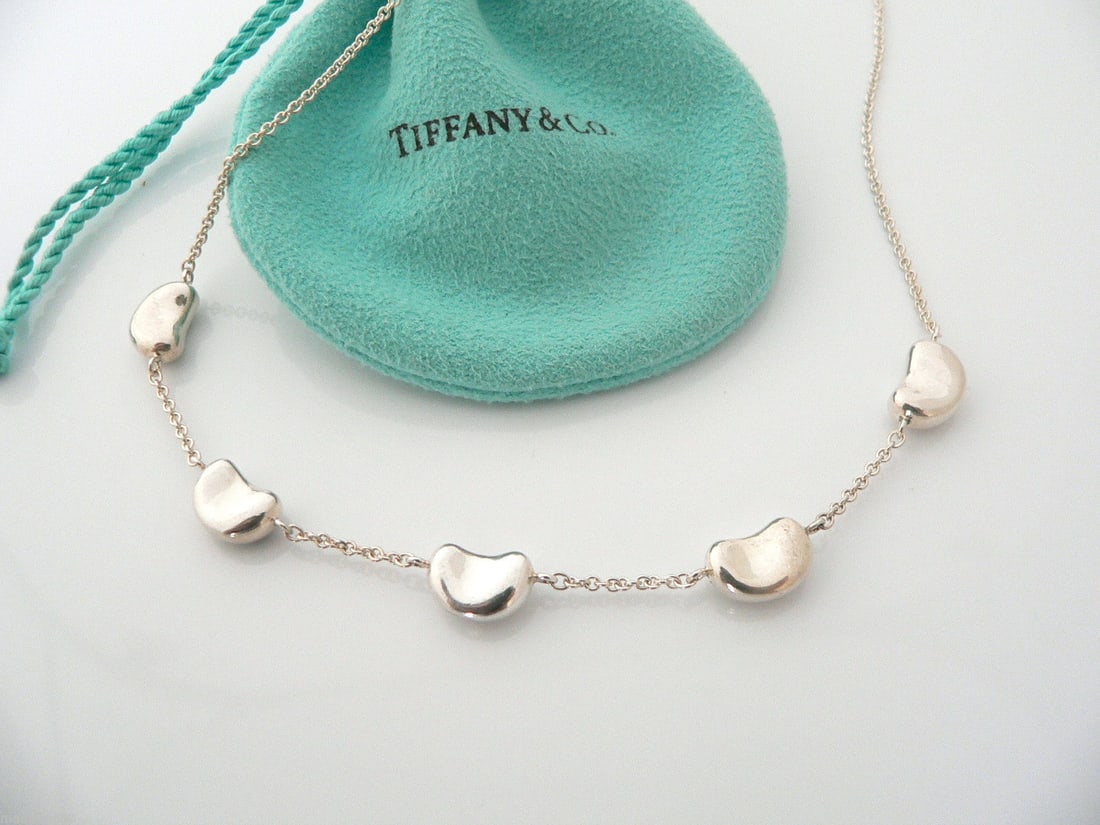 TIFFANY & Co. STERLING SILVER PERETTI 5 BEAN NECKLACE PENDANT w Pouch and Box Tiffany & Co. Elsa: TIFFANY & Co. STERLING SILVER PERETTI 5 BEAN NECKLACE PENDANT w Pouch and Box Tiffany & Co. Elsa Peretti?s 5 Bean necklace is a Tiffany classic that will never go out of style, marked ''Tiffany & Co. 