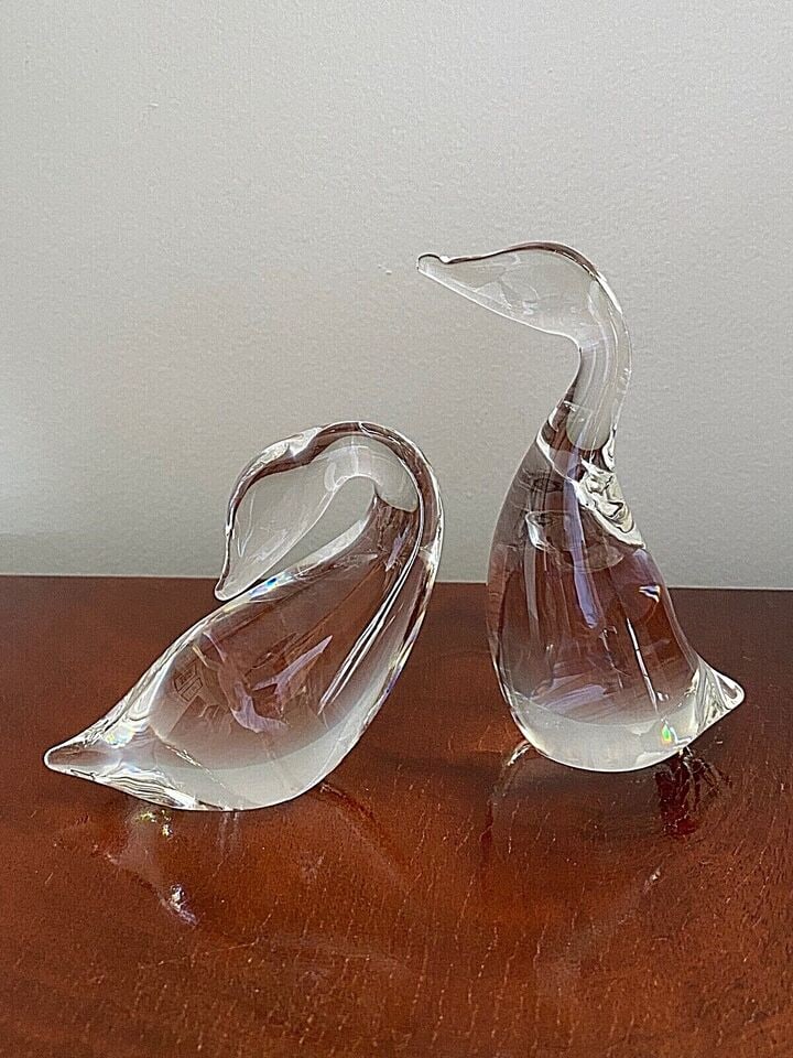 STEUBEN ART GLASS #8344 #8358 PREENING GOOSE & GANDER PAPERWEIGHT FIGURINES A pair of 1970's: STEUBEN ART GLASS #8344 #8358 PREENING GOOSE & GANDER PAPERWEIGHT FIGURINES A pair of 1970's vintage Steuben art glass goose and gander designed by Lloyd Atkins. The taller measures approximately 5.5