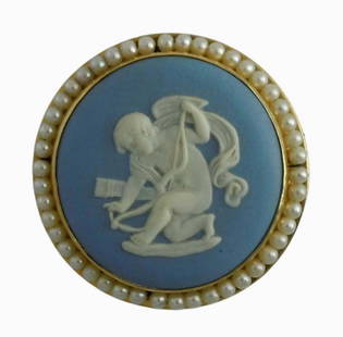 14K GOLD SEED PEARL WEDGWOOD BLUE JASPERWARE CUPID ANGEL BROOCH   Marked '14K WEDGWOOD MADE IN: 14K GOLD SEED PEARL WEDGWOOD BLUE JASPERWARE CUPID ANGEL BROOCHMarked '14K WEDGWOOD MADE IN ENGLAND S66' With a nice high relief depiction of cupid. DETAILS: - SIZE: 1-3/8 In. Diameter. - WEIGHT: 9.3