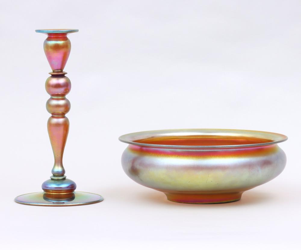 FAVRILE STYLE STEUBEN AURENE GLASS TABLE BOWL AND CANDLE STICK HOLDER Group of (2) Steuben Aurene: FAVRILE STYLE STEUBEN AURENE GLASS TABLE BOWL AND CANDLE STICK HOLDERGroup of (2) Steuben Aurene Glass Table Articles. To include: candlestick, numbered ''2956'' on bottom; and footed bowl with flare