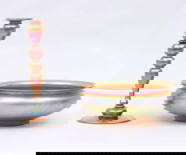 FAVRILE STYLE STEUBEN AURENE GLASS TABLE BOWL AND CANDLE STICK HOLDER   Group of (2) Steuben Aurene: FAVRILE STYLE STEUBEN AURENE GLASS TABLE BOWL AND CANDLE STICK HOLDERGroup of (2) Steuben Aurene Glass Table Articles.  To include: candlestick, numbered ''2956'' on bottom; and footed bowl with flare