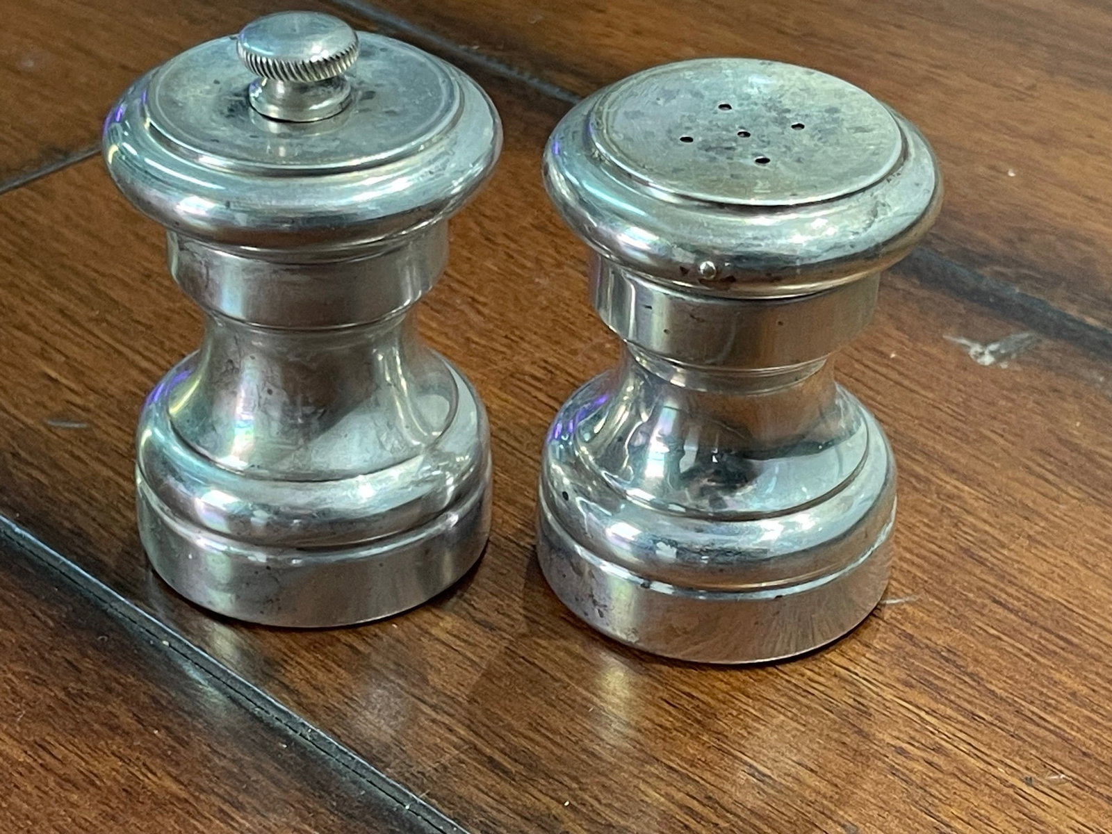 MID CENTURY CARTIER STERLING SILVER SALT & PEPPER SHAKERS With fine lines and form, the pepper: MID CENTURY CARTIER STERLING SILVER SALT & PEPPER SHAKERS With fine lines and form, the pepper shaker marked 'Made in Italy' the salt marked 'Cartier Sterling 7'. DETAILS: - SIZE: 2-1/4 In. Height x 1