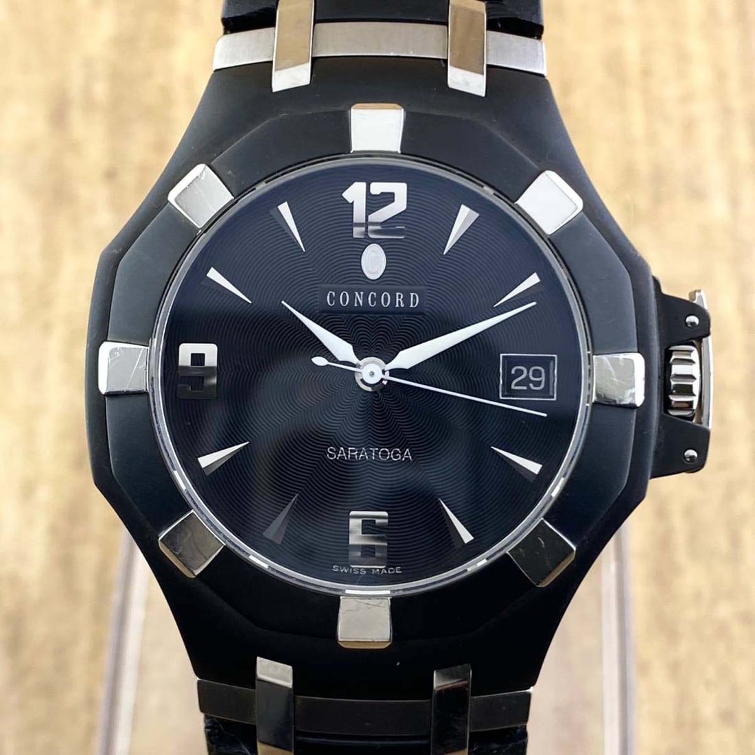 CONCORD SARATOGA 14 C2 1894 BLACK CERAMIC STAINLESS QUARTZ WATCH NOS w/ BIRDS EYE MAPLE BOX &: CONCORD SARATOGA 14 C2 1894 BLACK CERAMIC STAINLESS QUARTZ WATCH NOS w/ BIRDS EYE MAPLE BOX & PAPERS Circa 2004 with a Swiss quartz 955.112 Seven jewel movement, screw down water resistant case back, 