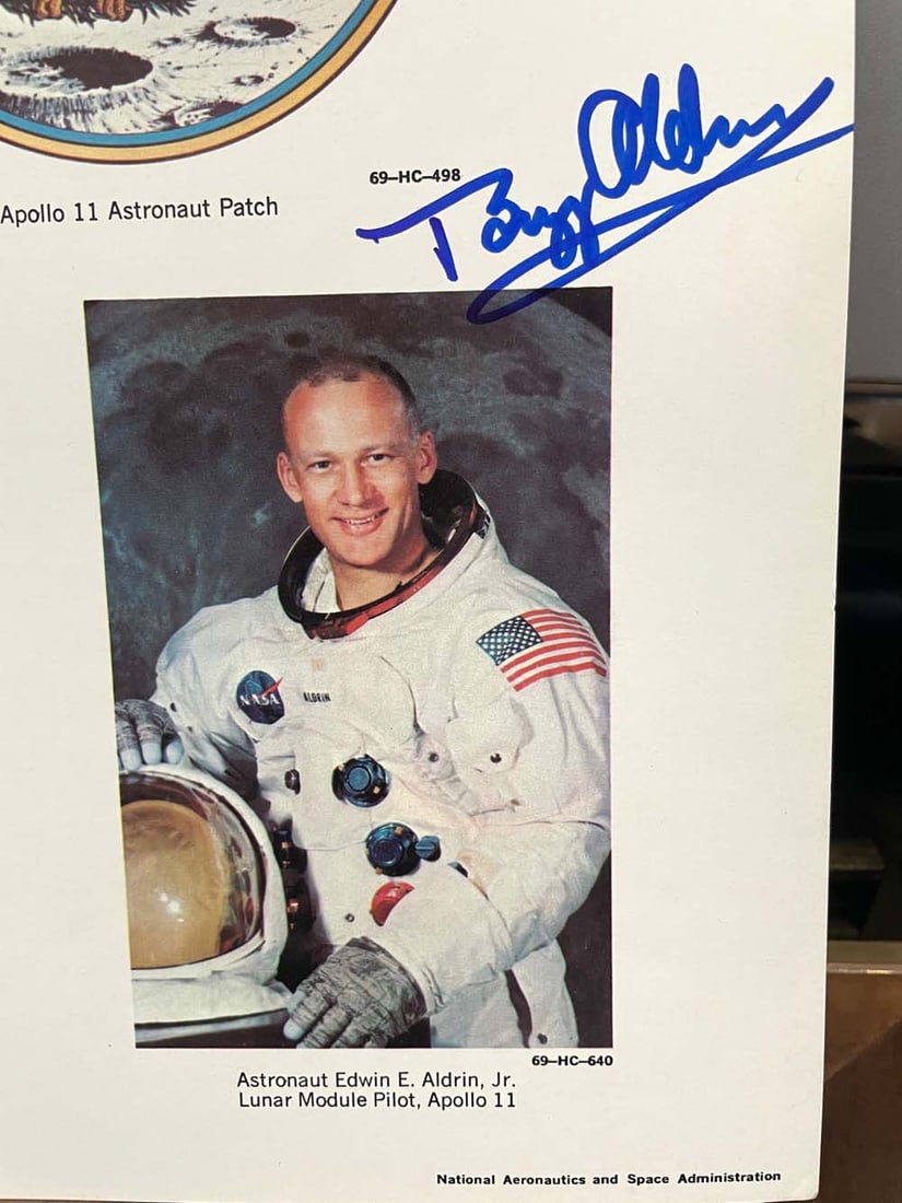 SIGNED BUZZ ALDRIN FIRST MEN ON THE MOON NASA PHOTO AUTOGRAPH First men on the moon astronaut: SIGNED BUZZ ALDRIN FIRST MEN ON THE MOON NASA PHOTO AUTOGRAPH First men on the moon astronaut lineup with Neil Armstrong, Michael Collins and signed Buzz Aldrin in blue felt tip marker (right) when he