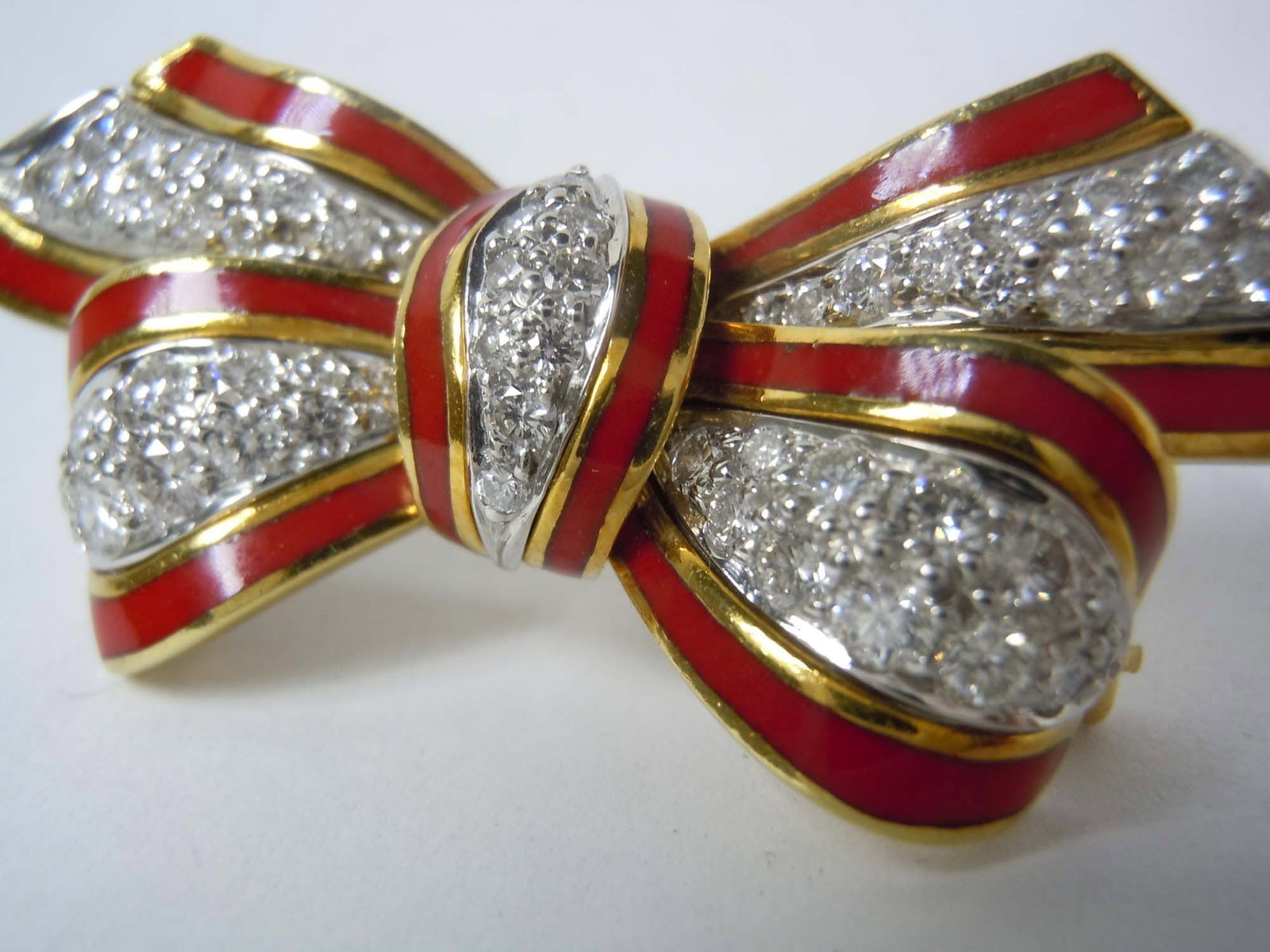 TIFFANY 18K DIAMOND ENAMEL BOW BROOCH, DONALD CLAFLIN A Rare Diamond, Enamel, Platinum & Gold: TIFFANY 18K DIAMOND ENAMEL BOW BROOCH, DONALD CLAFLIN A Rare Diamond, Enamel, Platinum & Gold ribbon/bow brooch, Attrib: Donald Claflin for Tiffany & Co., circa 1970 The brooch features pave set full-