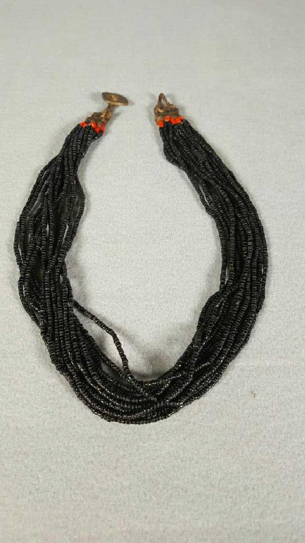 Naga Bead necklace, 13 strands of Black Naga: Beads From Nagaland India, hand made, clasp made with King George vi King Emperor 2 anna 1943 India coin, 23 1/2"