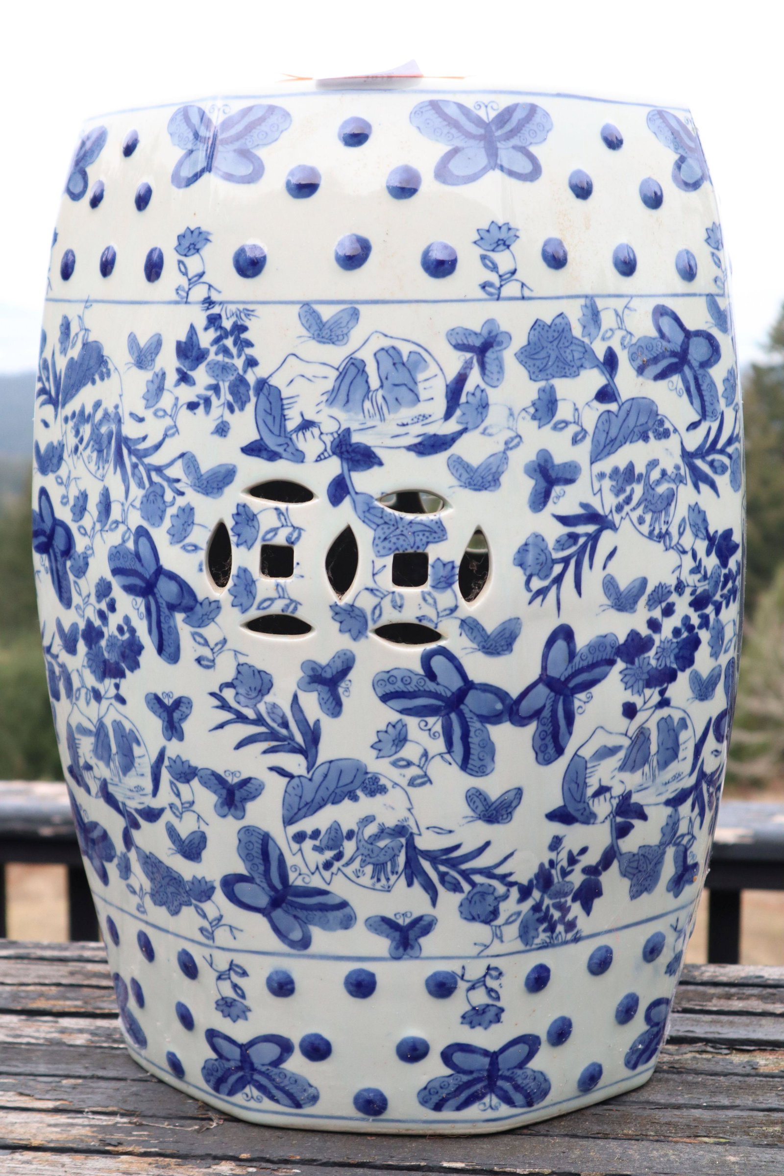 BLUE AND WHITE PORCELAIN GARDEN SEAT, BUTTERFLY AND FLORA MOTIF, DOUBLE PIERCED COIN ON SIDE AND TOP: Blue And White Porcelain Garden Seat, Butterfly And Flora Motif, Double Pierced Coin On Side, Pierced Coin On Top, 13X18.5 25#