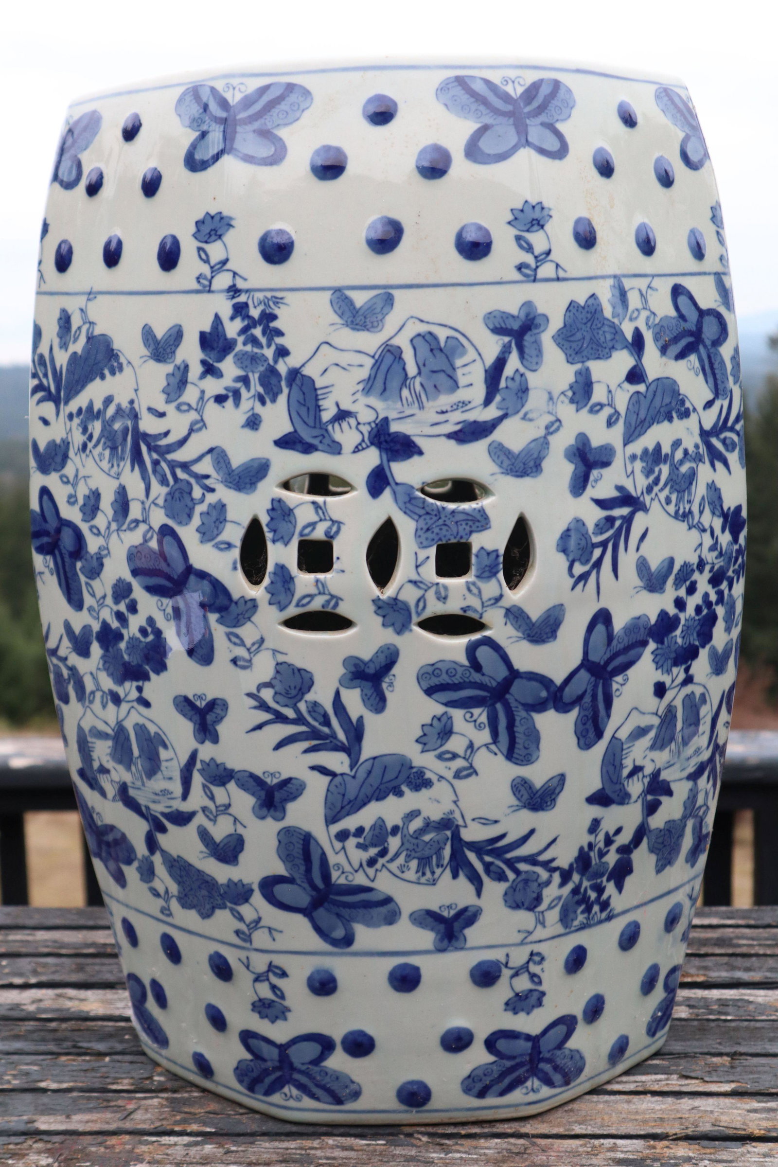 BLUE AND WHITE PORCELAIN GARDEN SEAT, BUTTERFLY AND FLORA MOTIF, DOUBLE PIERCED COIN ON SIDE AND TOP: Blue And White Porcelain Garden Seat, Butterfly And Flora Motif, Double Pierced Coin On Side, Pierced Coin On Top, 13X18.5 25#