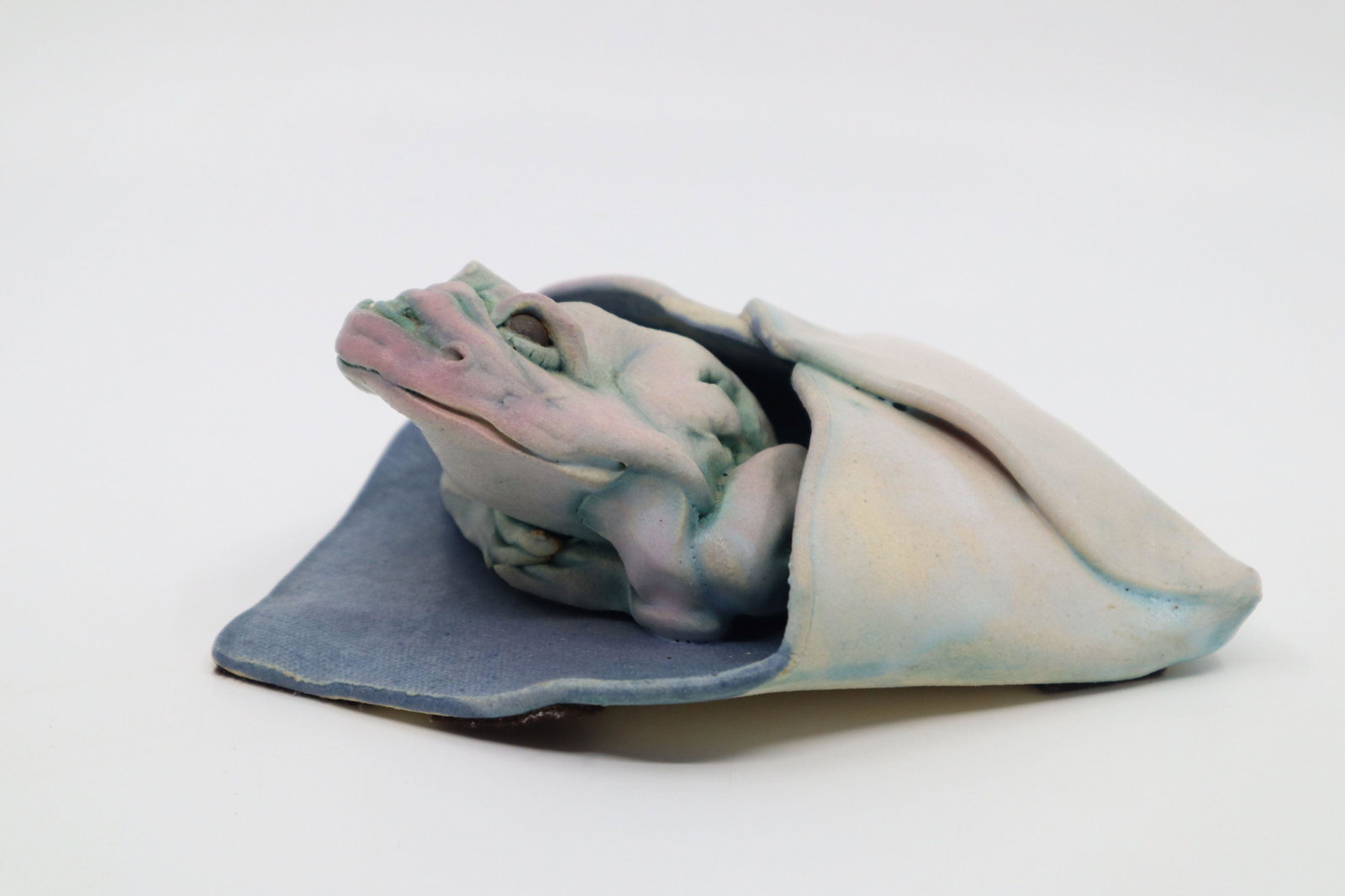 MARILYN STILES HANDMADE SCULPTURE, GREEN, PINK, TURQUOISE-BLUE AND WHITE GLAZED FROG IN AN ENVELOPE: Marilyn Stiles Handmade Sculpture, Green, Pink, Turquoise-Blue And White Glazed Frog Emerging From An Envelope, 7X6X3"H, Signed, 1996. Marilyn Stiles, WA. (Unknown - 2018) After Graduating In Art Educ