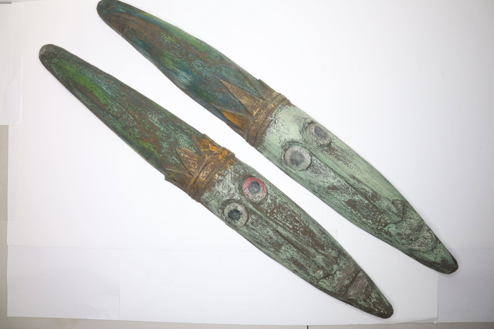 2 CARVED INDONESIAN WOOD SCULPTURAL WALL HANGINGS, GREEN PAINTED LONG FACES WITH CROWNS, 5X39"H: 2 Carved Indonesian Wood Sculptural Wall Hangings, Green Painted Long Faces With Crowns, 5X39"H