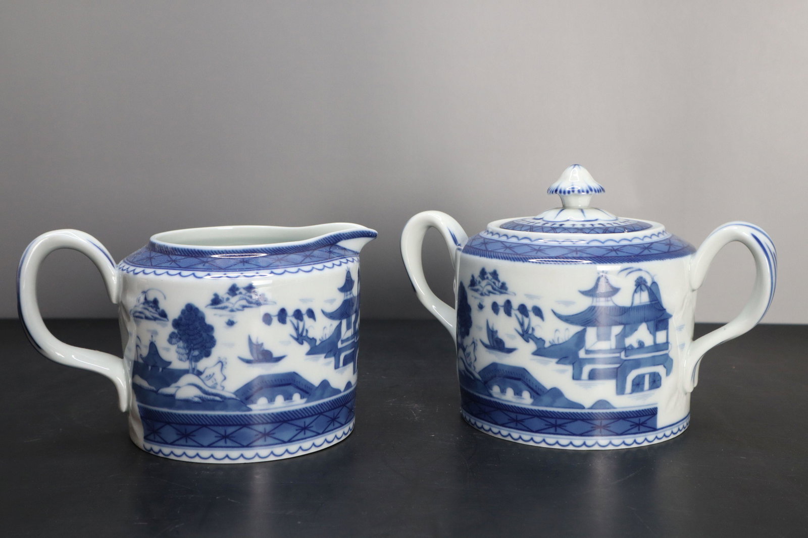MOTTAHEDEH CANTON CHINESE BLUE AND WHITE PORCELAIN CREAM AND SUGAR WITH LID AND MOLDED HANDLE: Mottahedeh Canton Chinese Blue And White Porcelain Cream And Sugar With Lid And Molded Handle, Marked On Bottom, Historic Charleston Reproductions VA Portugal, 5.5X3.5" And 6.5X4.5"