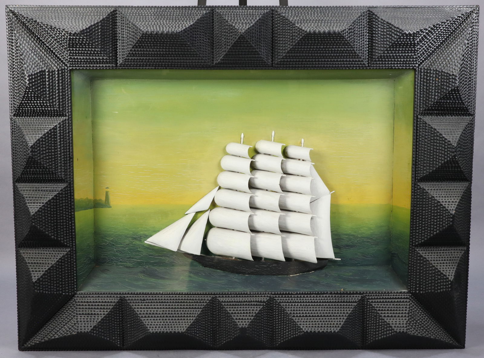 MONUMENTAL TRAMP ART CARVED WOOD FRAME SHIP DIORAMA IN SHADOW BOX, 44X8X33"H: MONUMENTAL TRAMP ART CARVED WOOD FRAME SHIP DIORAMA IN SHADOW BOX PAINTED BLACK DIMENSIONS: 44X8X33"H CONDITION: See Images For Condition