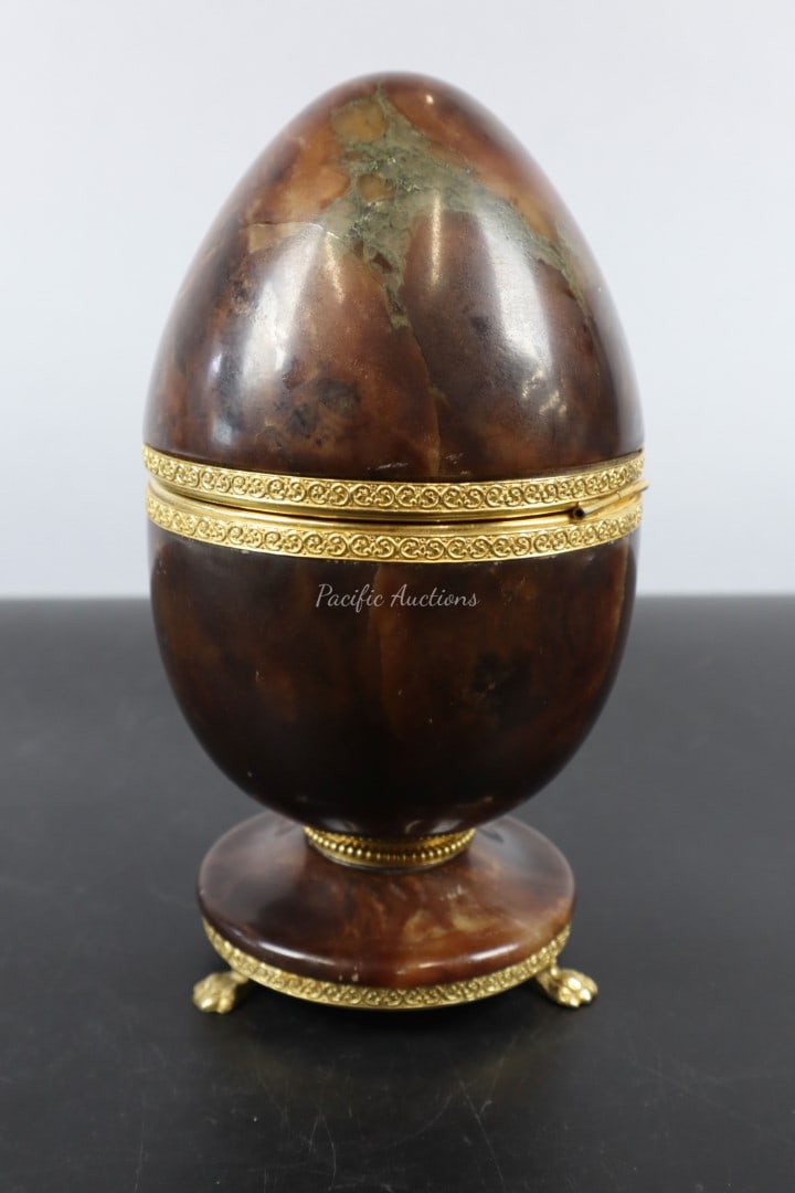 CARVED STONE AND ORMOLU EGG BOX, 4x7.5"H: DESCRIPTION: CARVED STONE AND ORMOLU EGG BOX, 4x7.5"H WEIGHT: CONDITION: Please see photos for condition. Condition is commensurate with age and use. We aim to take additional photos of any noticeable