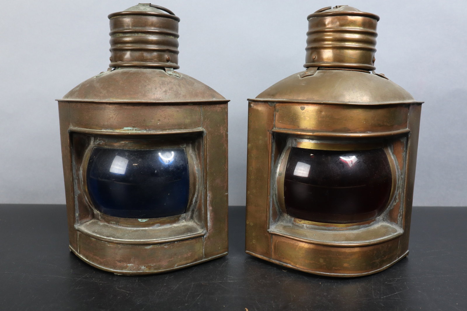 VINTAGE NAUTICAL SHIP LANTERNS, BRASS STARBOARD AND PORT SIGNAL LANTERN SET, WITH RED AND BLUE: DESCRIPTION: VINTAGE NAUTICAL SHIP LANTERNS, BRASS STARBOARD AND PORT SIGNAL LANTERN SET, WITH RED AND BLUE GLASS, 9.5", 11" HANGING, MOUNTING BRACKET ON BACK CONDITION: Please See Photos For Conditio