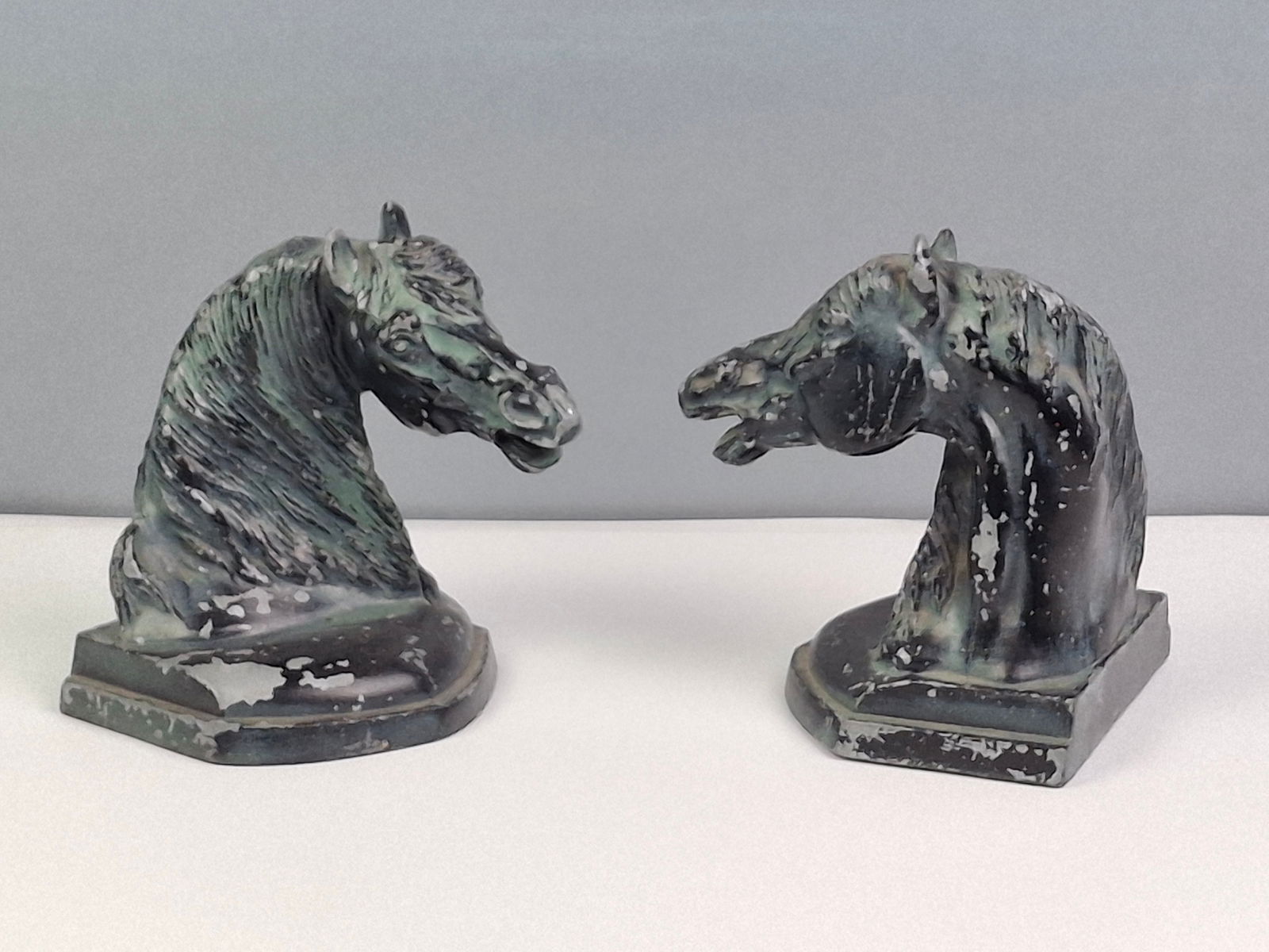 VINTAGE CAST METAL HORSE HEAD BOOKENDS, PAINTED BLACK WITH GREEN, RUSTIC 4 X 5 X 6: DESCRIPTION: VINTAGE CAST METAL HORSE HEAD BOOKENDS, PAINTED BLACK WITH GREEN, RUSTIC 4 X 5 X 6. CONDITION: Some paint missing. Please See Photos For Condition. Condition Is Commensurate With Age And