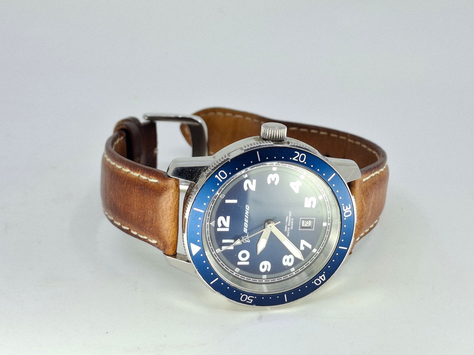 BOEING BLUE DIAL WATCH WITH BROWN LEATHER BAND: DESCRIPTION: BOEING BLUE DIAL WATCH WITH BROWN LEATHER BAND. CONDITION: Please See Photos For Condition. Condition Is Commensurate With Age And Use. We Aim To Take Additional Photos Of Any Noticeable