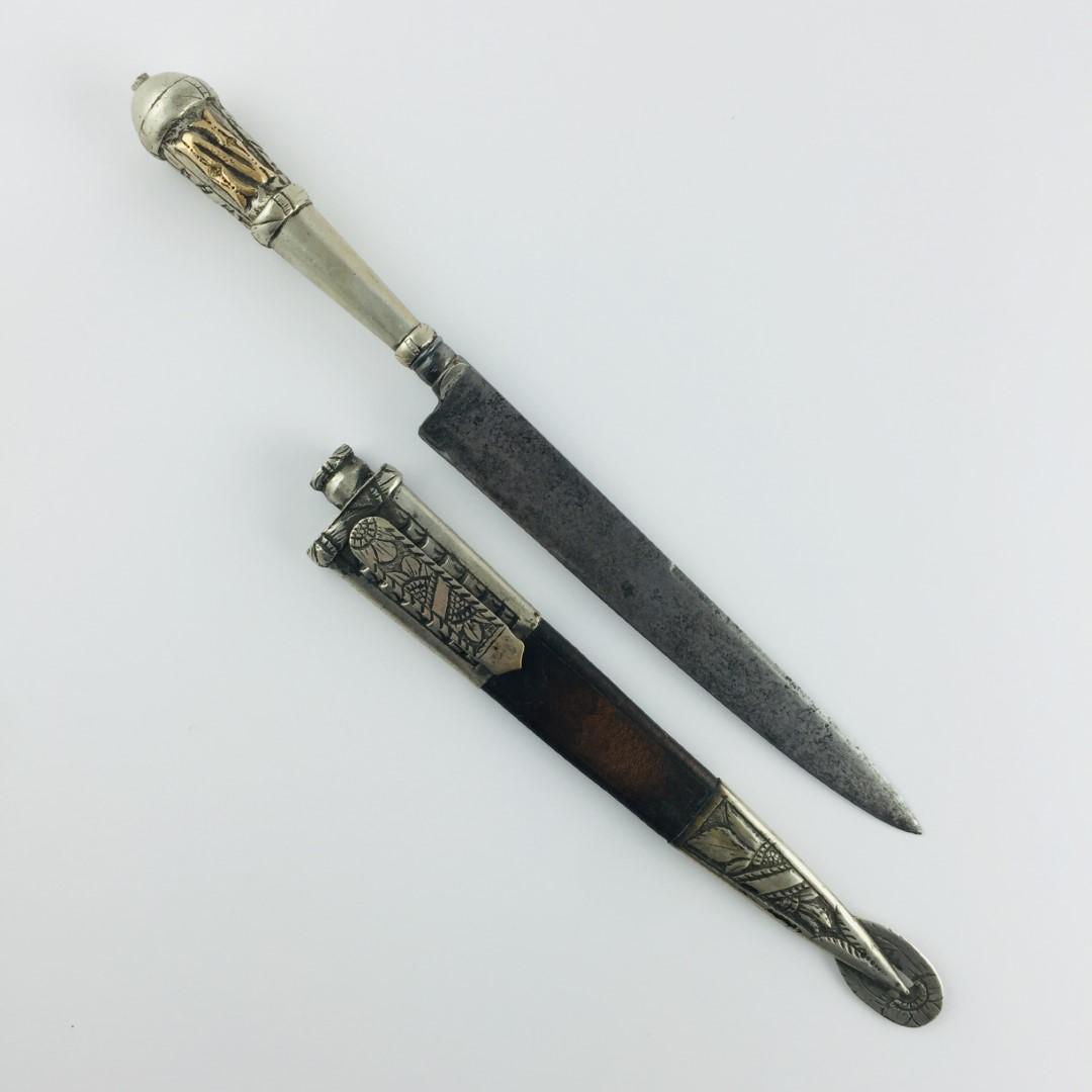 Gaucho knife: Gaucho knife. "amello" blade. Handle in silver with initials "J.N." in gold. Brown leather Picasa sheath, with silver chiselled "leaves and flowers" mouth and tip. Total length 32.5 cm. Cuchillo criol