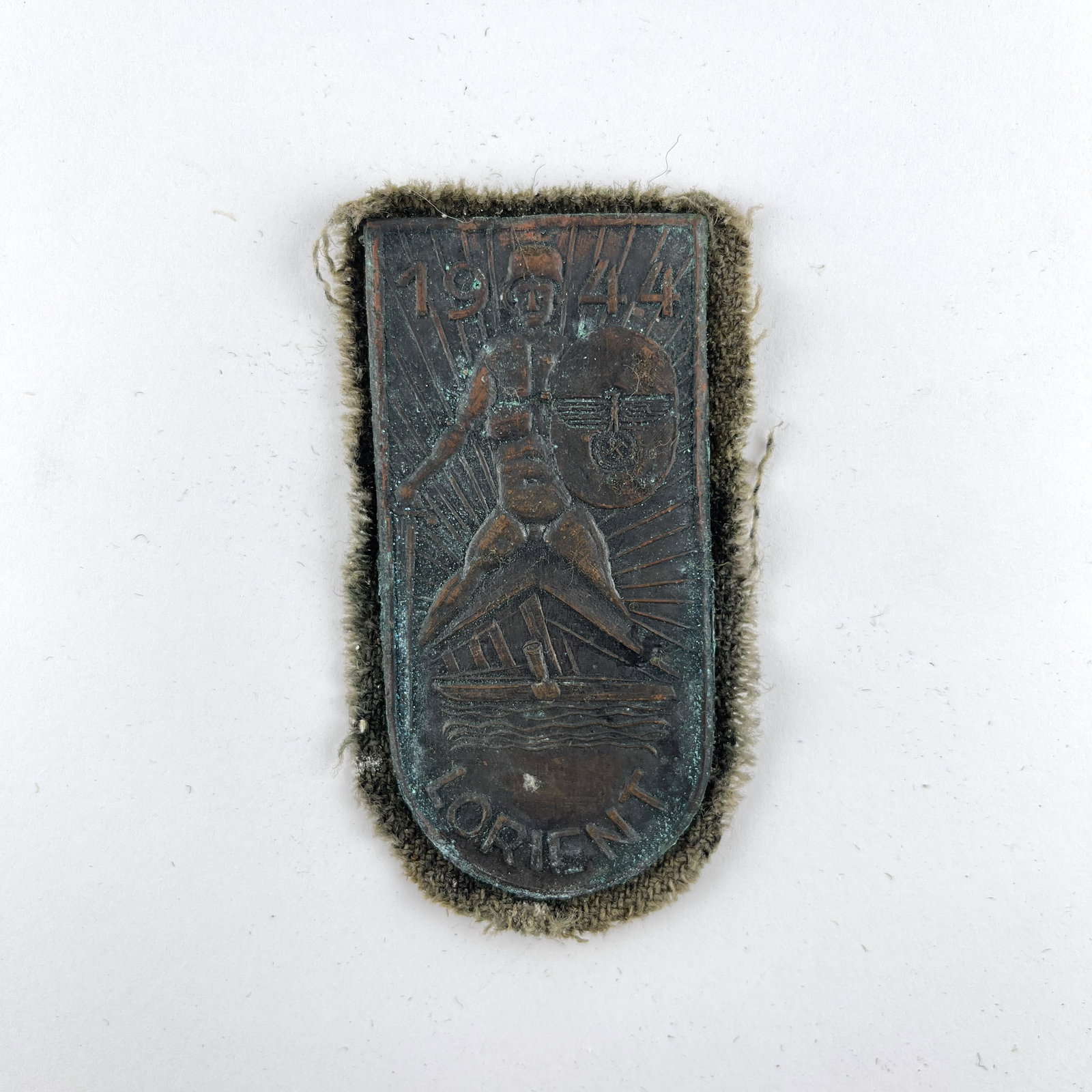 German 1944 1945 insignia: German insignia in stamped copper. "1944. Lorient." 80 x 37 mm.Insignia alemana en cobre estampado. "1944. Lorient." 80 x 37 mm.